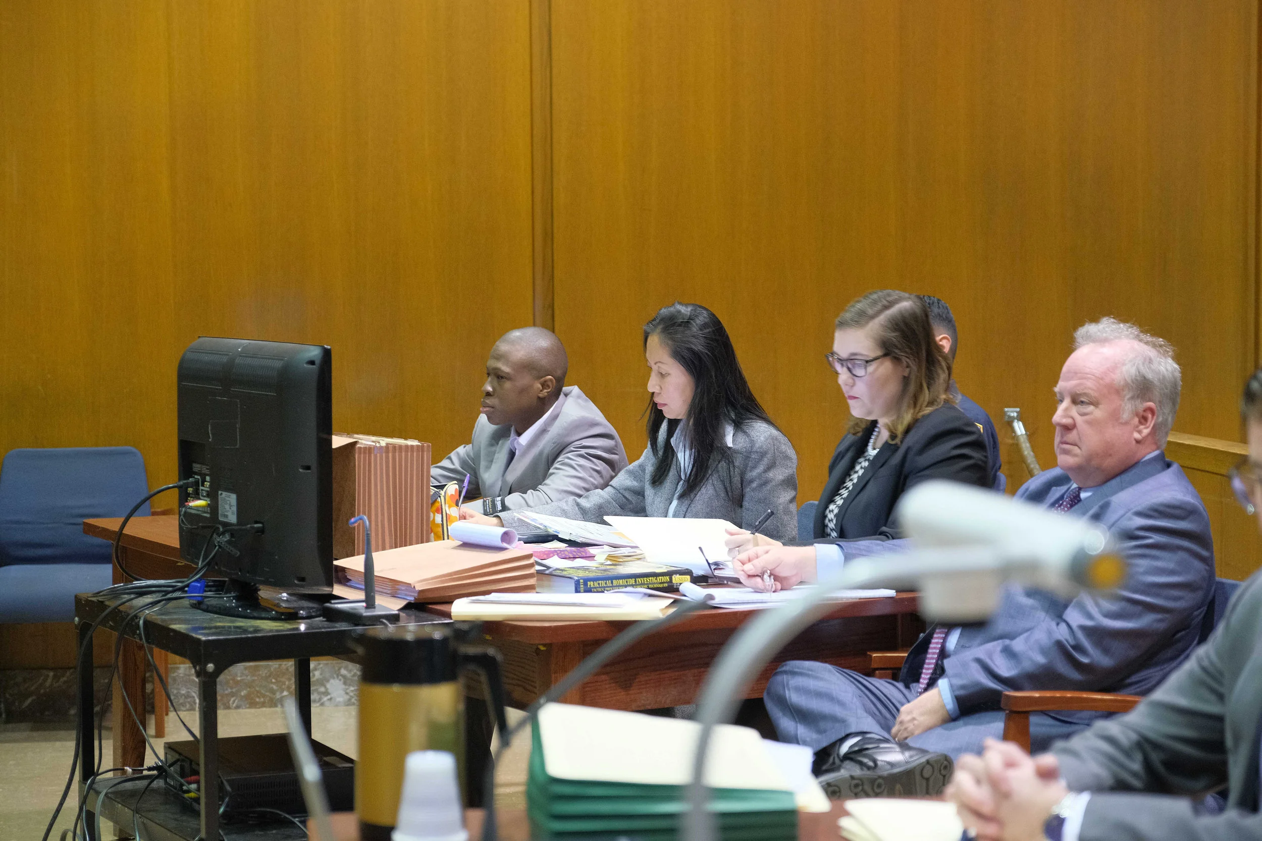 Chanel Lewis (far left) on trial for the murder of Karina Vetrano. Lewis is seated with defense team Jenny Cheung (middle left), Julia Burke (middle right) and Robert Moeller (right). Pool photo by Curtis Means.