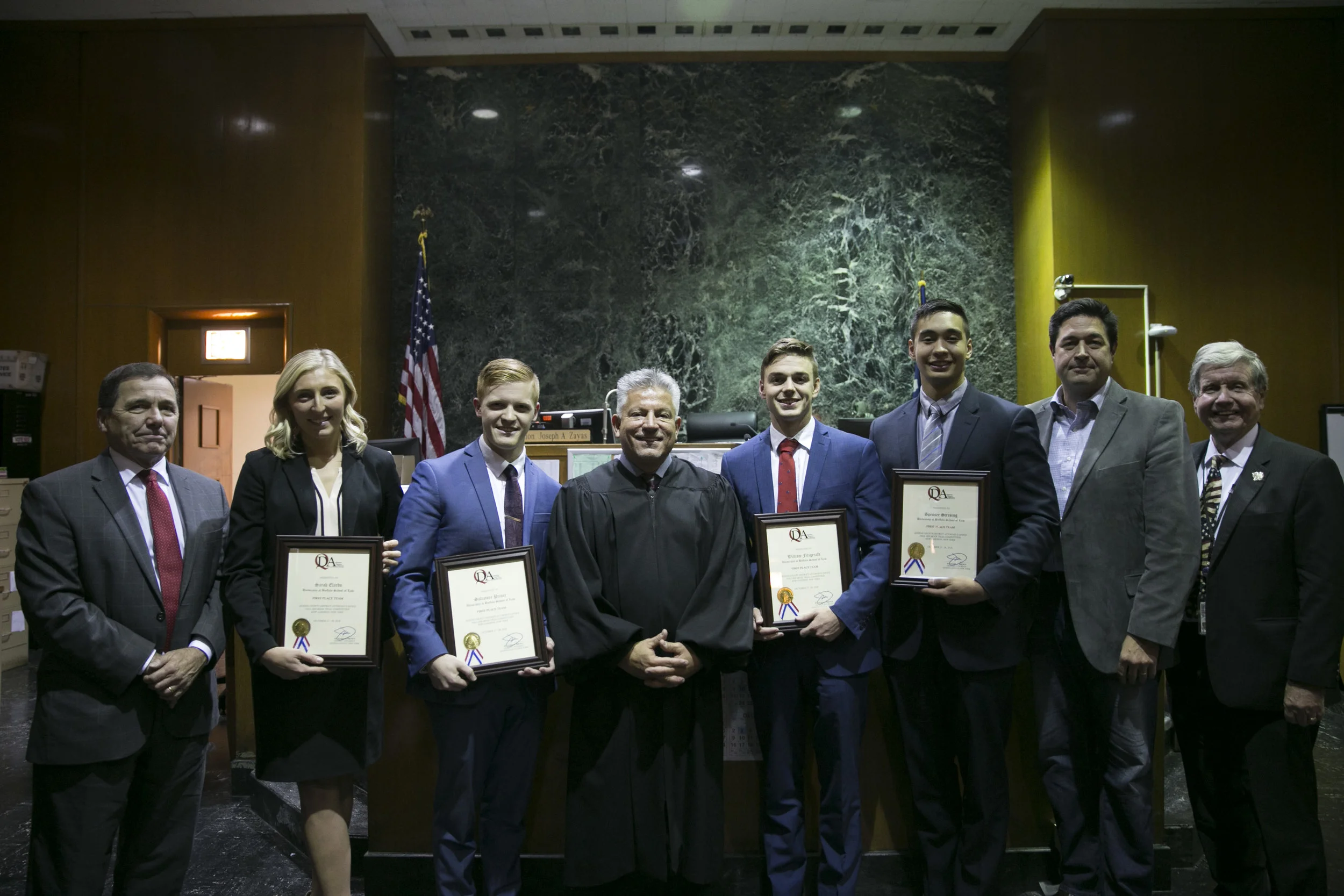 The law students on the University of Buffalo School of Law team stand with Administrative Judge of the Queens Criminal Division Hon. Joseph Zayas, Senior Executive Assistant District Attorney James C. Quinn, and Chief Assistant District Attorney John M. Ryan after winning the Queens County District Attorney Office 5th Annual Mock Trial Competition on October 28 in the Queens Criminal Courthouse in Kew Gardens. Eagle photo by Clarissa Sosin.