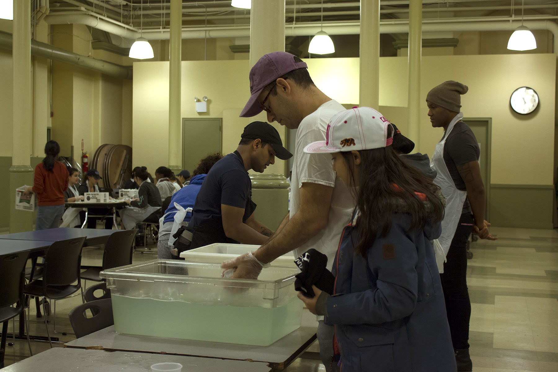 Joe Gentile and his two children help prepare for the Sunday rush at the Xavier Mission.