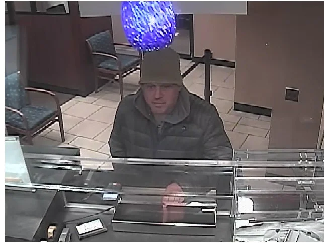 Still image of Victor Larson allegedly leaving a Chase Bank and Capital One Bank on Oct. 16. Photos courtesy of NYPD.