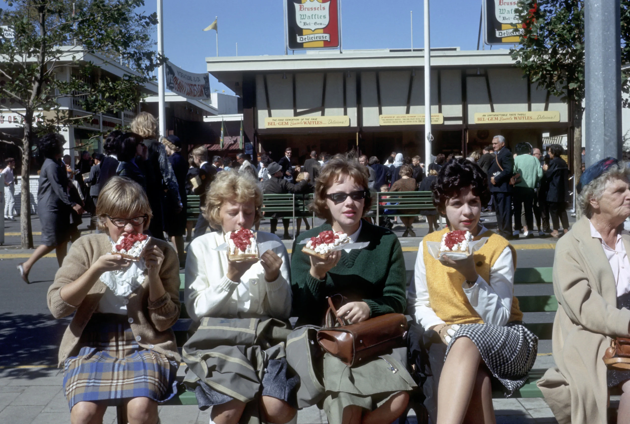 Four young women eat Belgian waffles near the State Pavilion at the 1964 World’s Fair. // Photo courtesy of QEDC