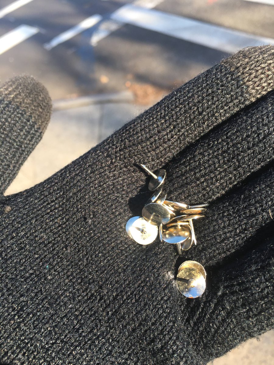 Councilmember Jimmy Van Bramer holding thumb tacks that were found scattered in bike lanes across 43rd Avenue in Sunnyside on Thursday. Twitter photo via Councilmember Jimmy Van Bramer.