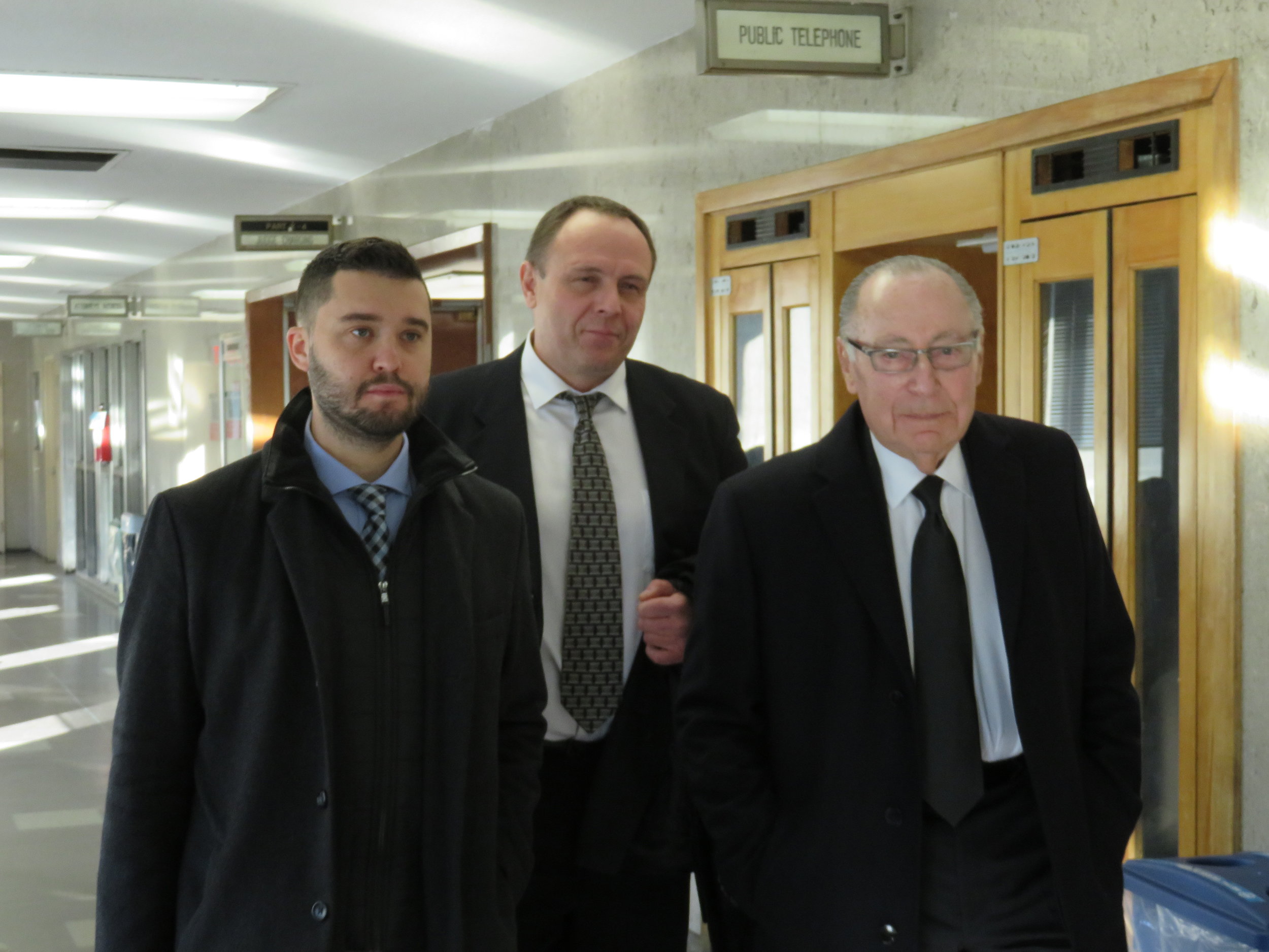 Yuriy Kruk (center) walks through the courthouse with defense attorneys Marvyn Kornberg (right) and Dmitriy Shakhnevich (left) after Justice Richard Buchter acquitted him at a bench trial. Eagle photo by David Brand.