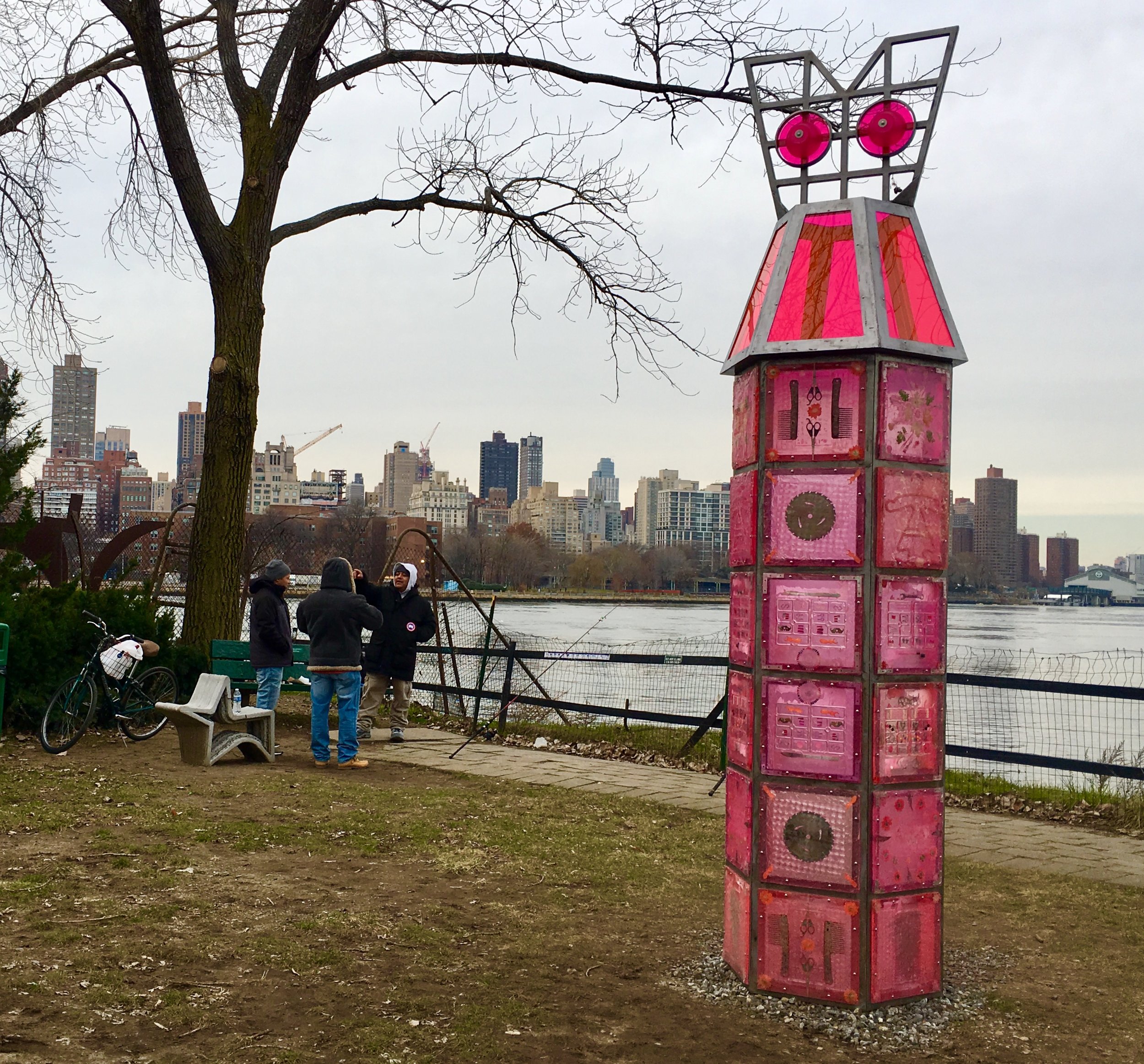Folks are fishing beside “Fort-Dress,” a sculpture by Amy Brener at Socrates Sculpture Park.