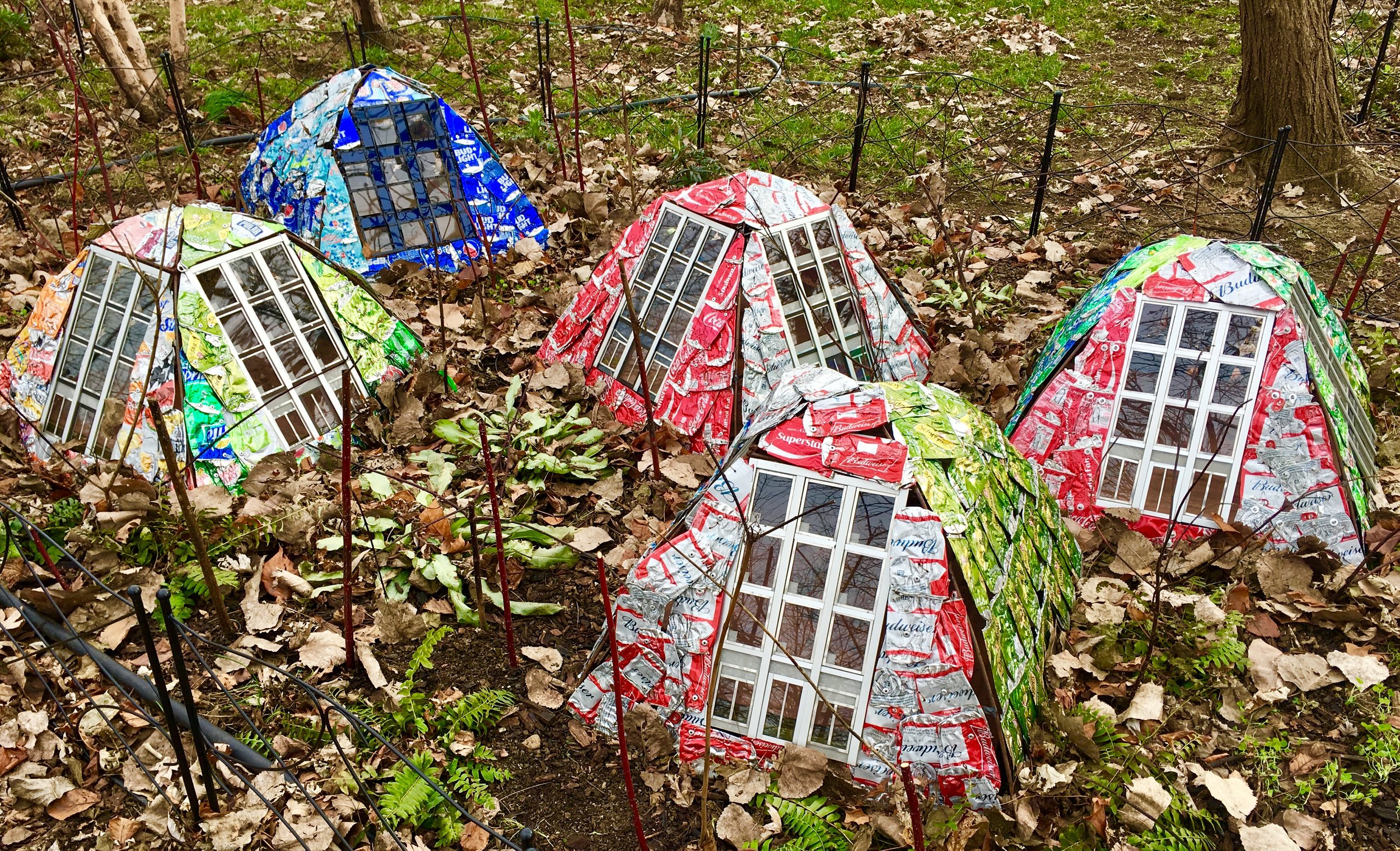These structures covered with flattened aluminum cans are part of artist Ronen Gamil’s work “Home(-) and Garden” at Socrates Sculpture Park.