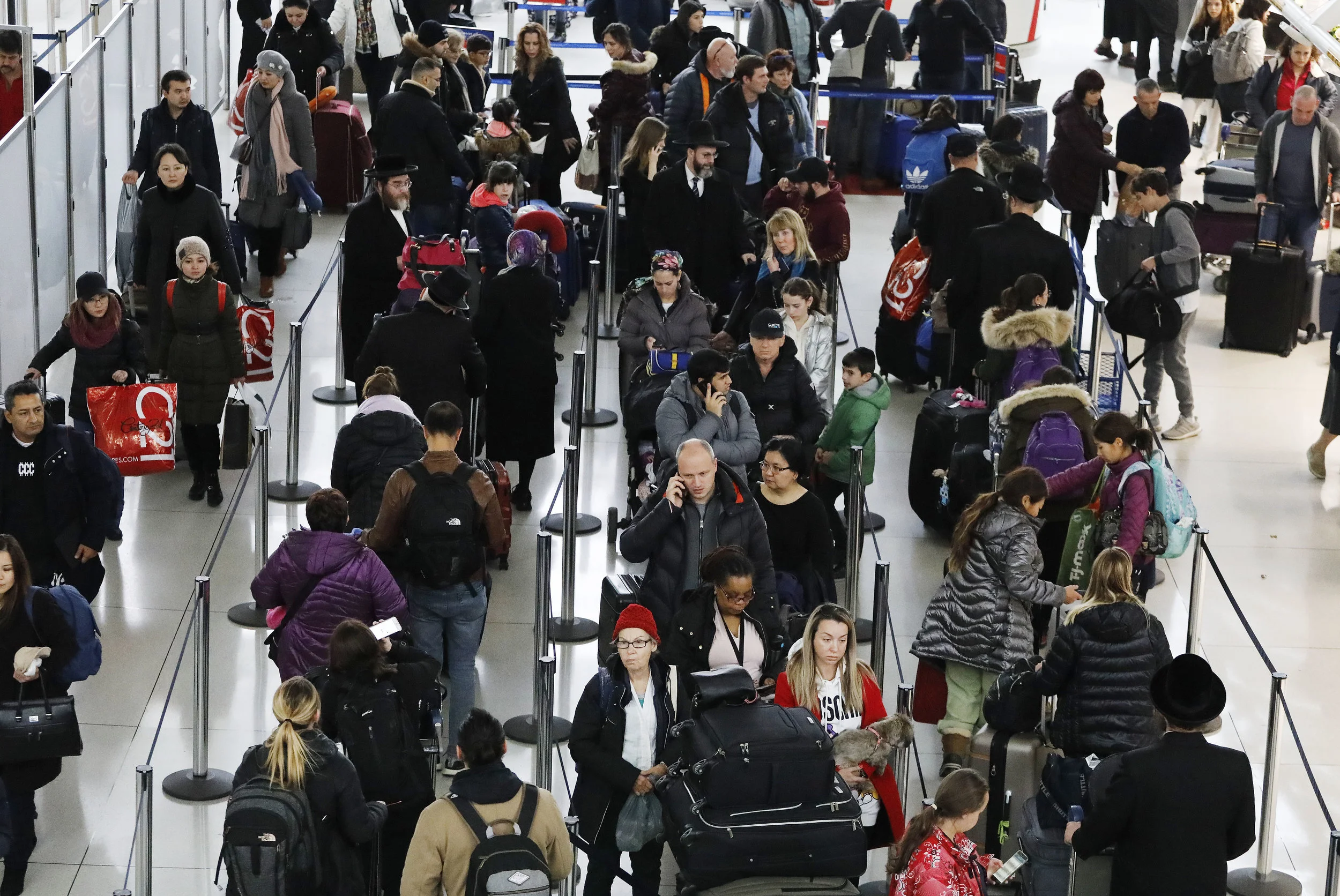 Travelers check in for flights at Kennedy Airport on Nov. 21. AP Photo/Mark Lennihan.