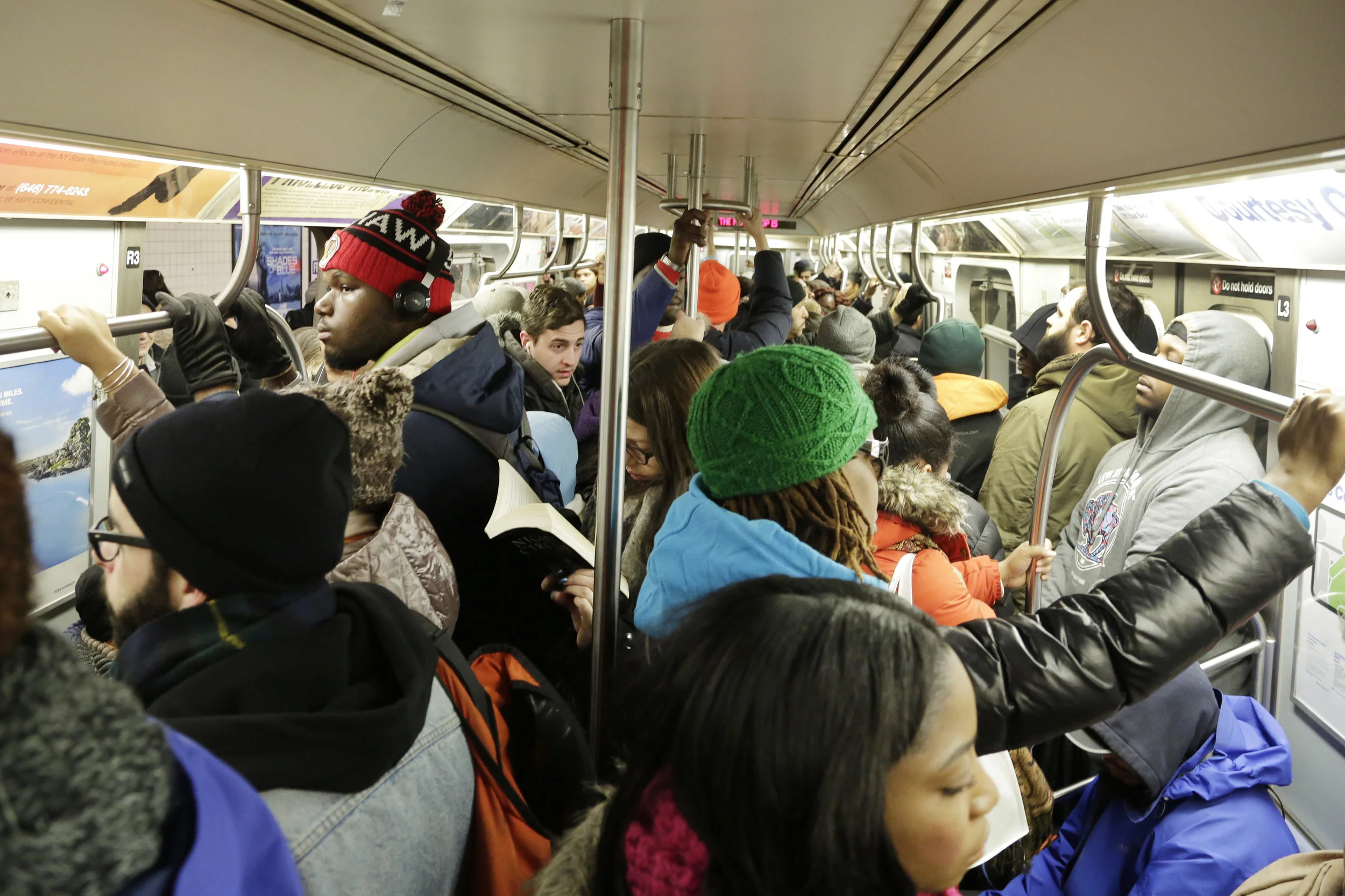 Commuters crowd an L subway train, Monday, Jan. 25, 2016, in the Brooklyn borough of New York. AP Photo/Mark Lennihan.