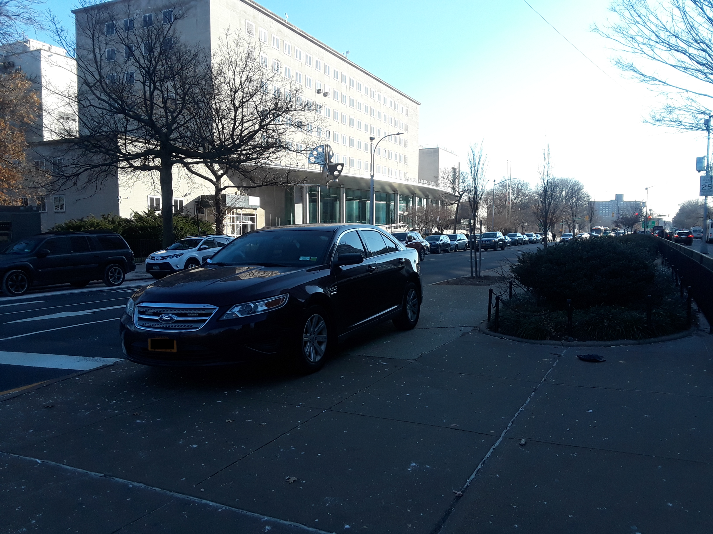 Burgundy car parked on the median of Queens Boulevard on Dec. 11 without a ticket. The anonymous reporter with NYP plates received a ticket for parking on the same median.