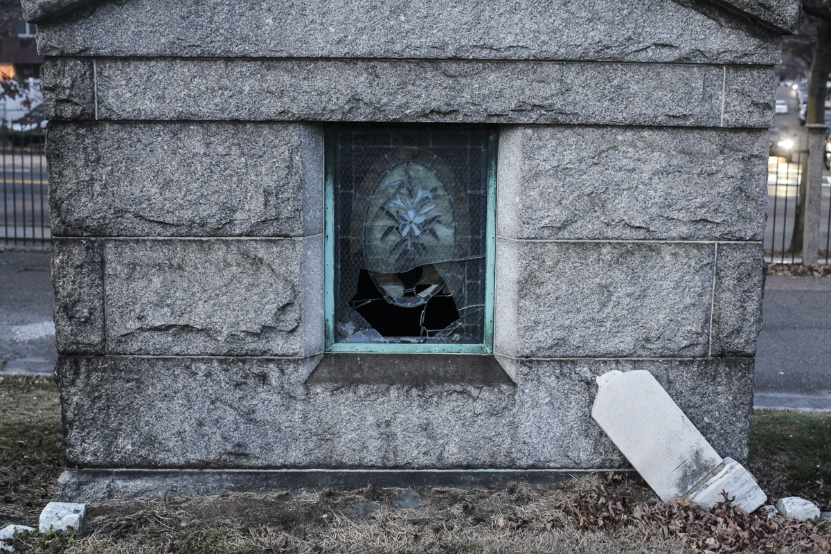 The shattered window of a mausoleum at All Faiths Cemetery in Middle Village.