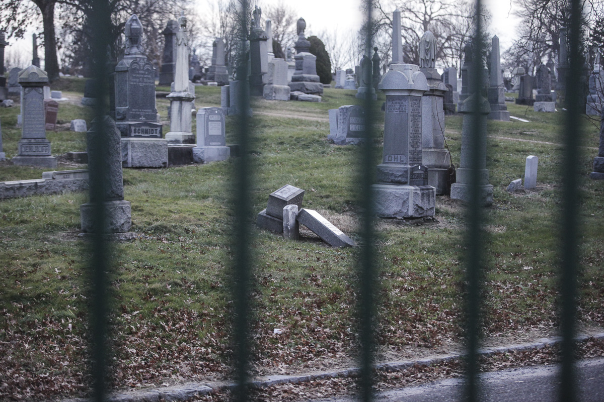 A broken monument at All Faiths Cemetery.