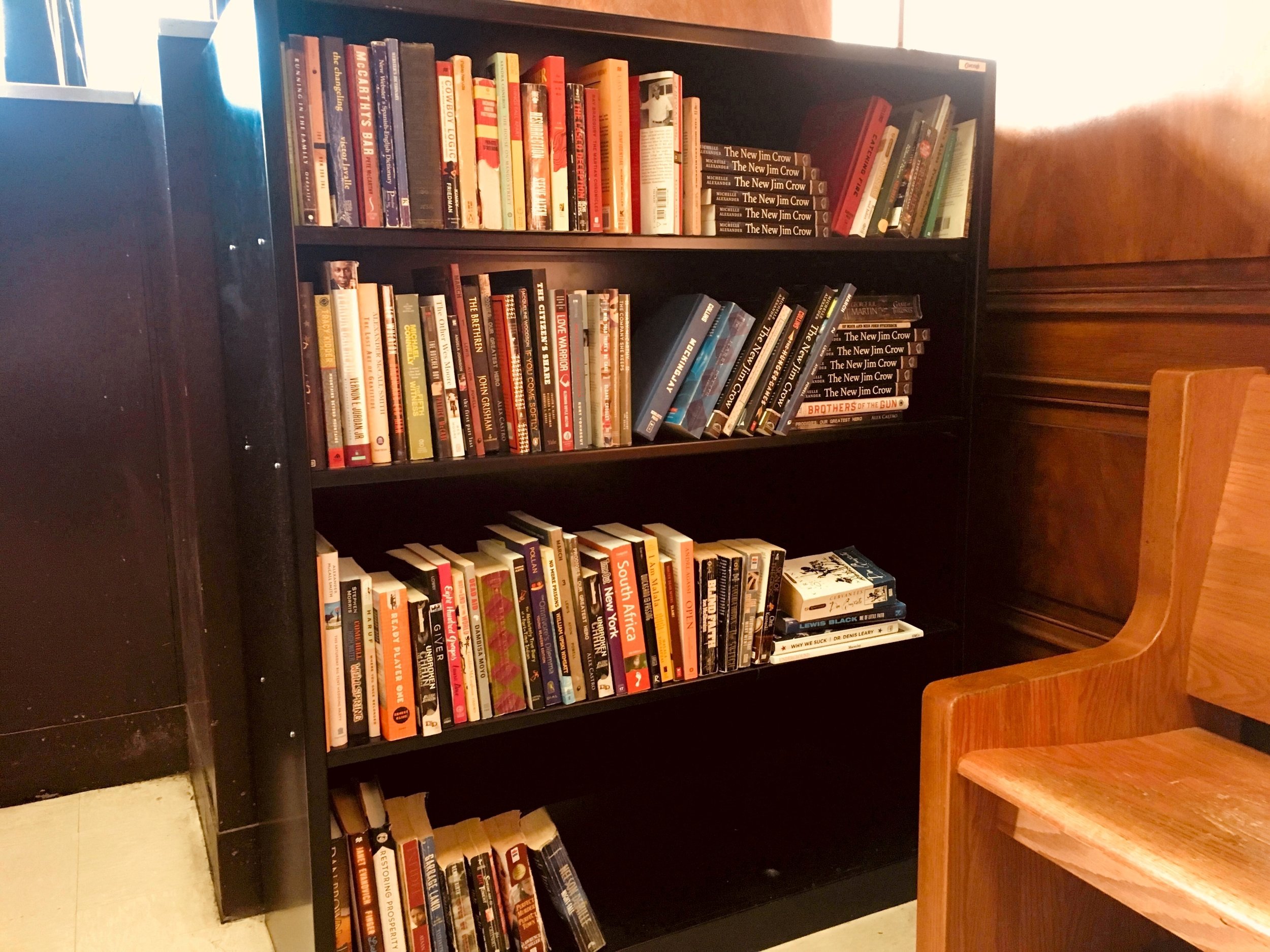 A new shelf of books at Brooklyn Adolescent and Young Adult Diversion Court. Legal Aid said it plans to introduce book in Queens as well. Photo courtesy of Legal Aids.