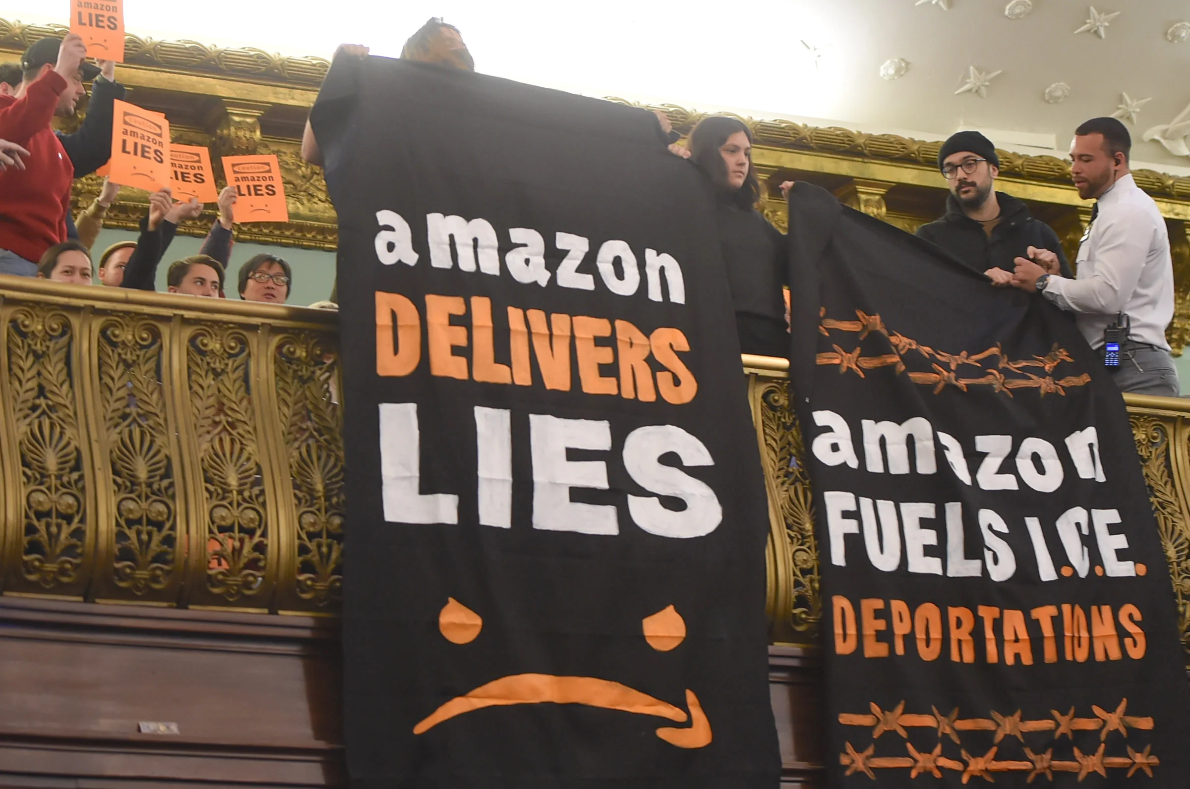 Protesters in front row of the City Council chamber display their disdain for the Amazon deal. Eagle photos by Todd Maisel.