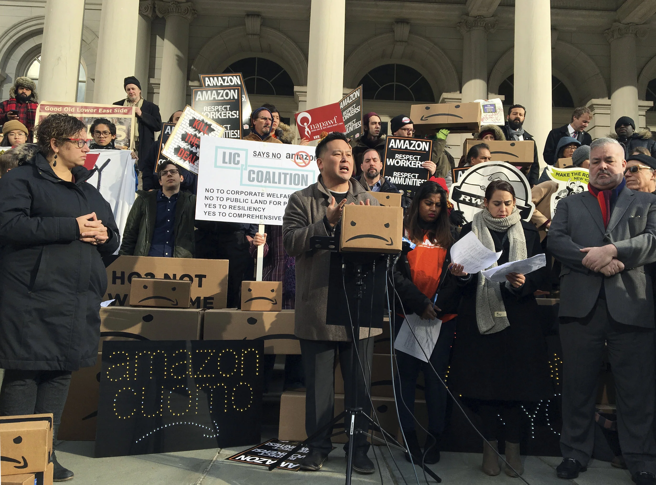 State Assemblymember Ron Kim, center, speaks at a rally opposing New York's deal with Amazon on the steps of City Hall. Kim is running for New York City Public Advocate. AP Photo/Karen Matthews.