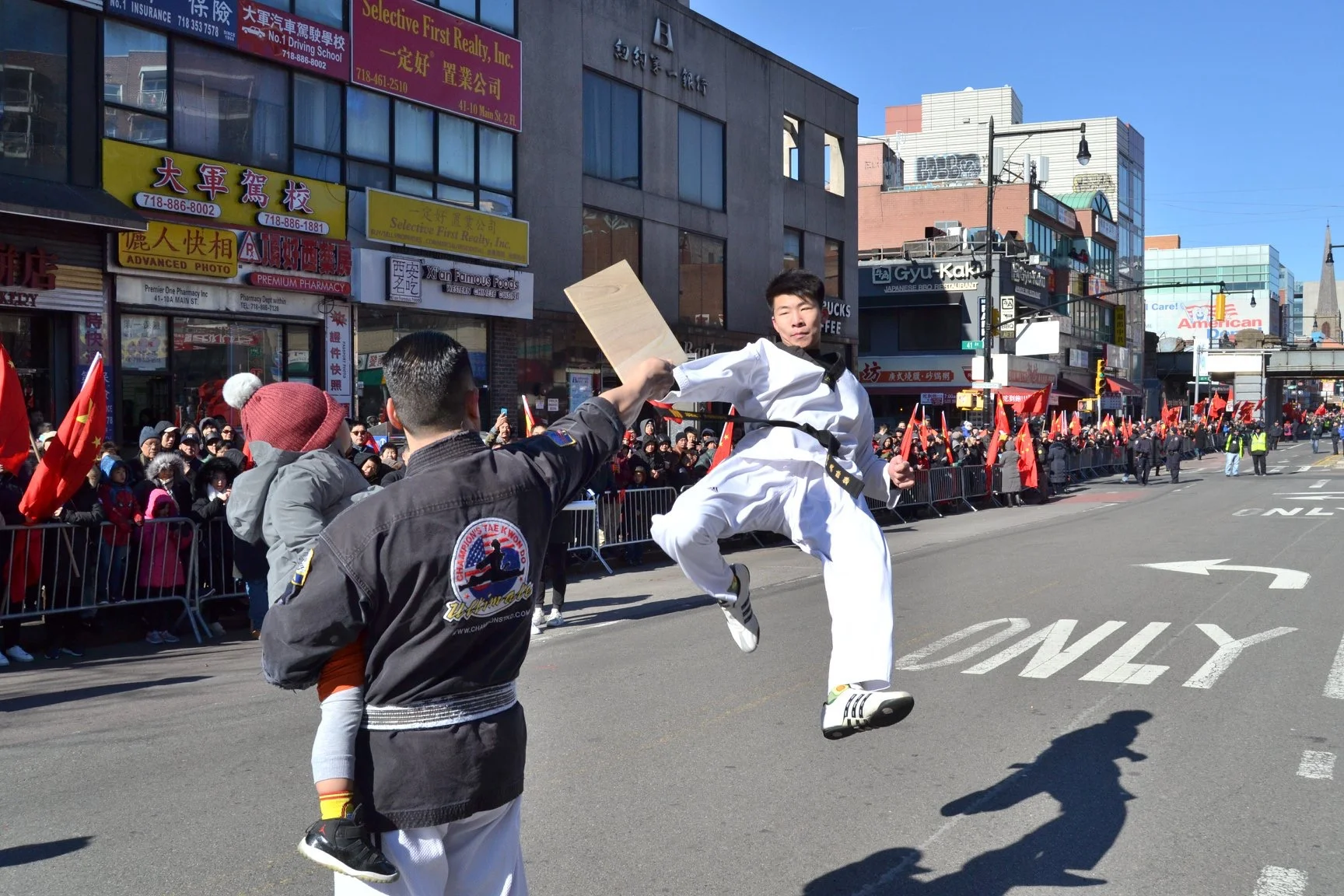 An Ultimate Champions Taekwondo student performs at Flushing’s Lunar New Year Parade. Photo courtesy of Ultimate Champions Taekwondo