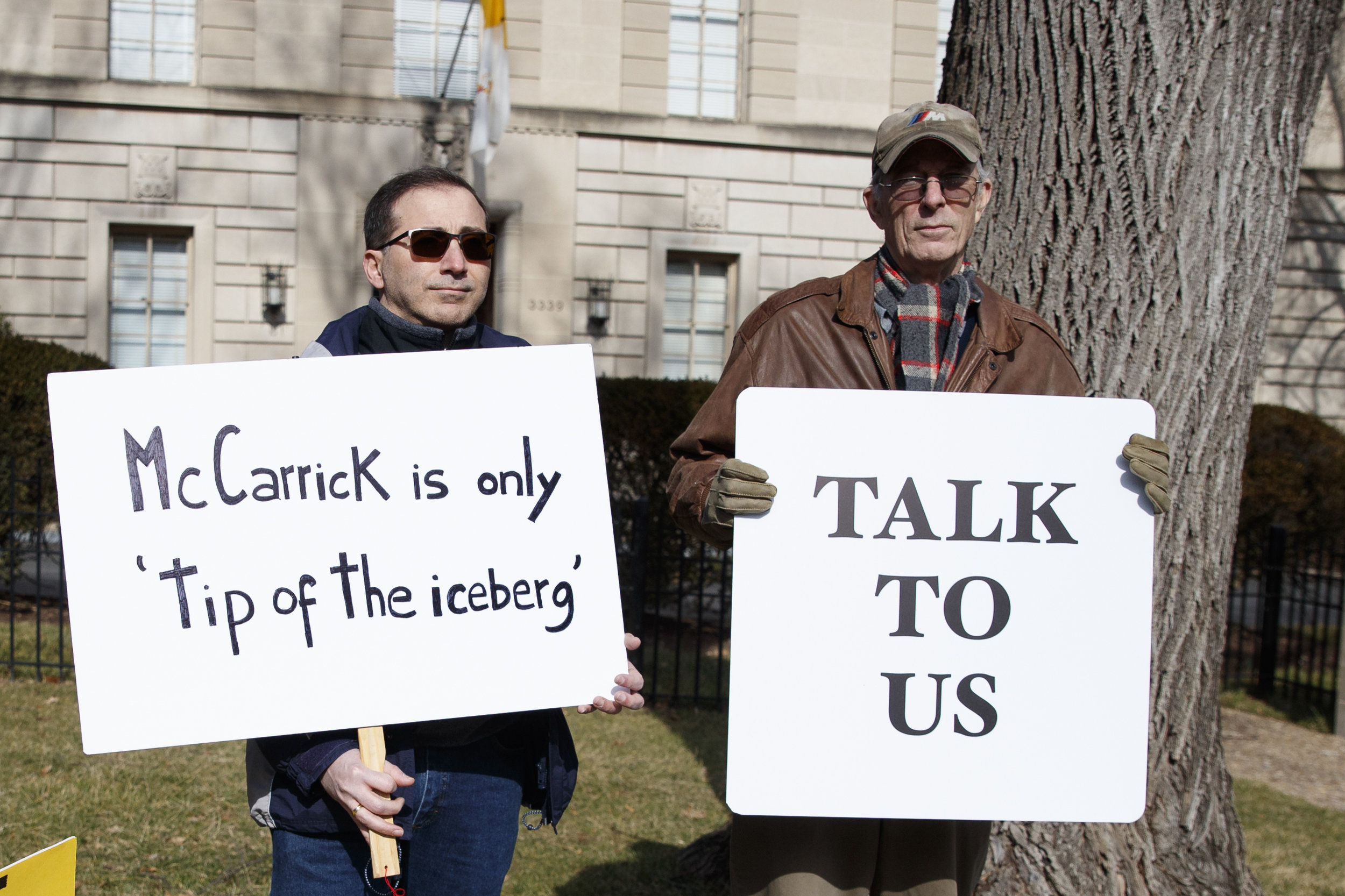 Luis Carvallo (left) holds a sign that reads "McCarrick is only the 'tip of the iceberg,'" and Bob Foss holds a sign that reads "Talk to Us" outside the Apostolic Nunciature of the Holy See in Washington, D.C., on Saturday. Pope Francis defrocked former U.S. Cardinal Theodore McCarrick after Vatican officials found him guilty of soliciting for sex while hearing confession and of sexual crimes against minors and adults. AP Photo/Carolyn Kaster.