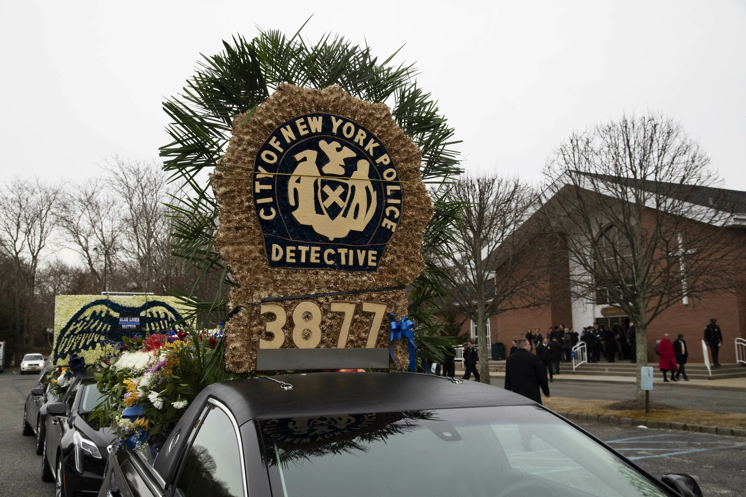 A limousine from the funeral procession for Det. Brian Simonsen, is parked in front of the Church of St. Rosalie in Hampton Bays, NY on Wednesday. AP Photo/Mark Lennihan.