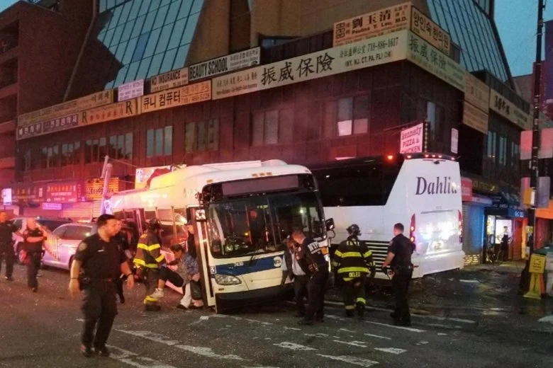 Officers respond to a collision involving two buses on Main Street in Flushing on Sept. 18, 2017. Federal safety investigators say a freak accident involving a dropped thermos may have caused the crash, which killed three people. Photo by NYPD's 109th Precinct via AP, File