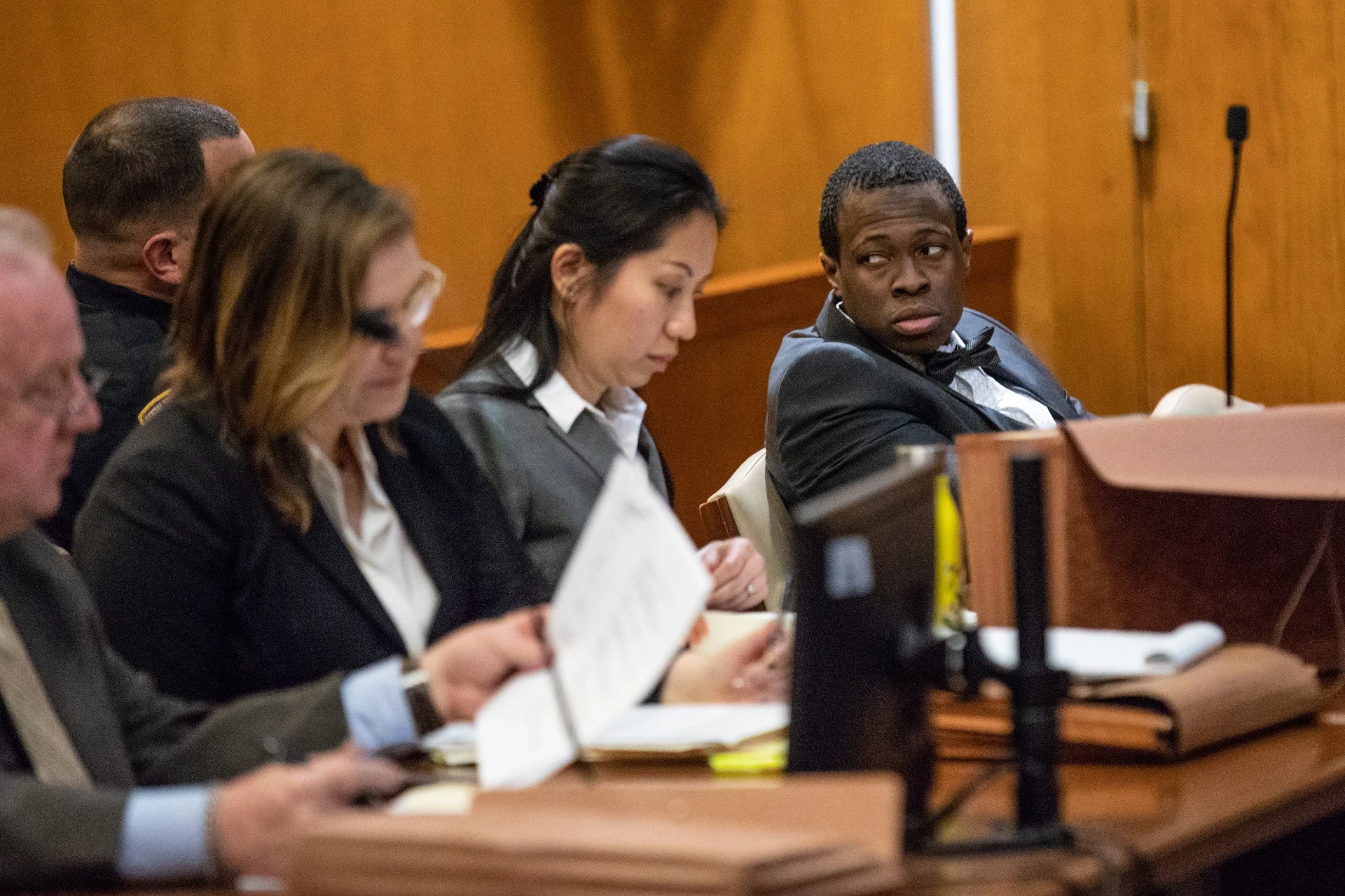 Chanel Lewis (right) glances into the gallery during opening statements in his murder retrial. Lewis is charged with first-degree murder for allegedly killing Karina Vetrano near her Howard Beach home. Pool photo by Uli Seit.