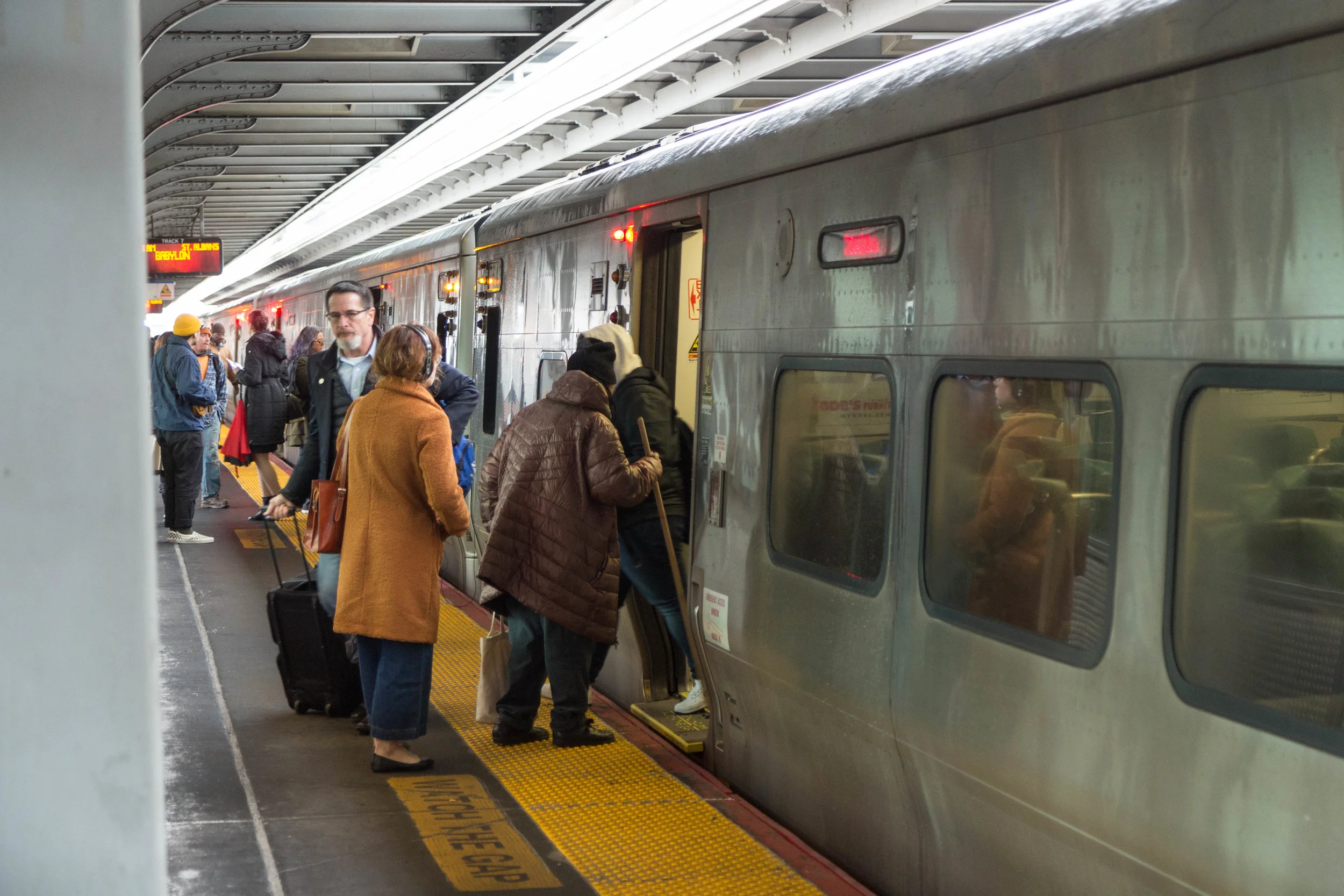 Riders board a train at the Jamaica LIRR station. Eagle photos by Jonathan Sperling.