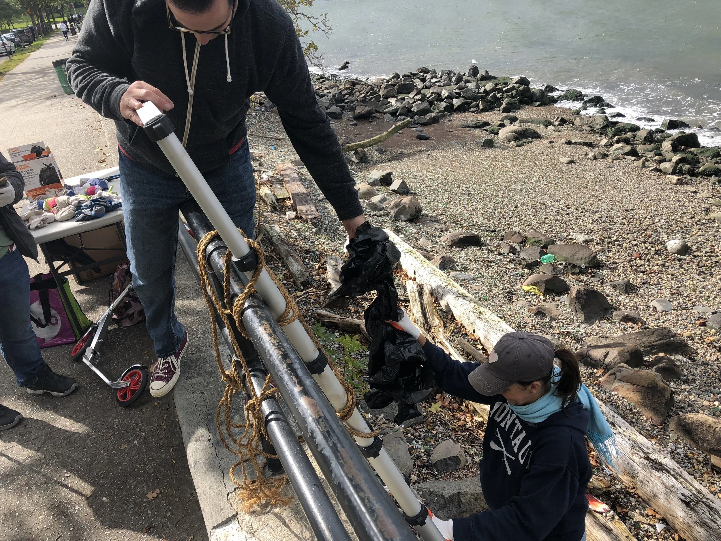 Volunteers from the Astoria Park Alliance cleanup the park’s shoreline.