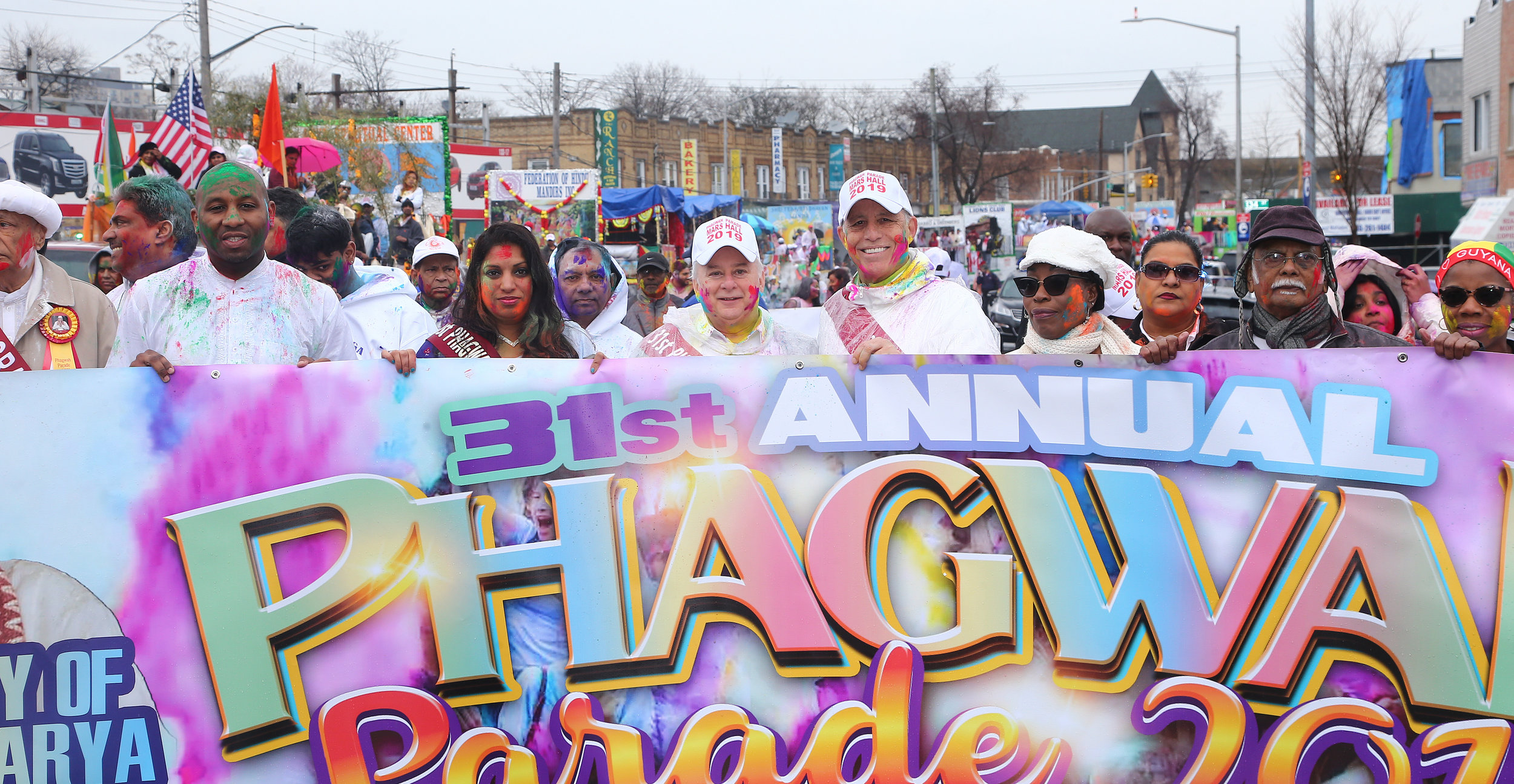  From left, Councilmember Donovan Richards, the Hon. Karen Gopee, the Hon. Gregory Lasak, attorney Todd Greenberg and the Guayanese Consul General Barbara Atherly hold the Phagwah Parade banner. 