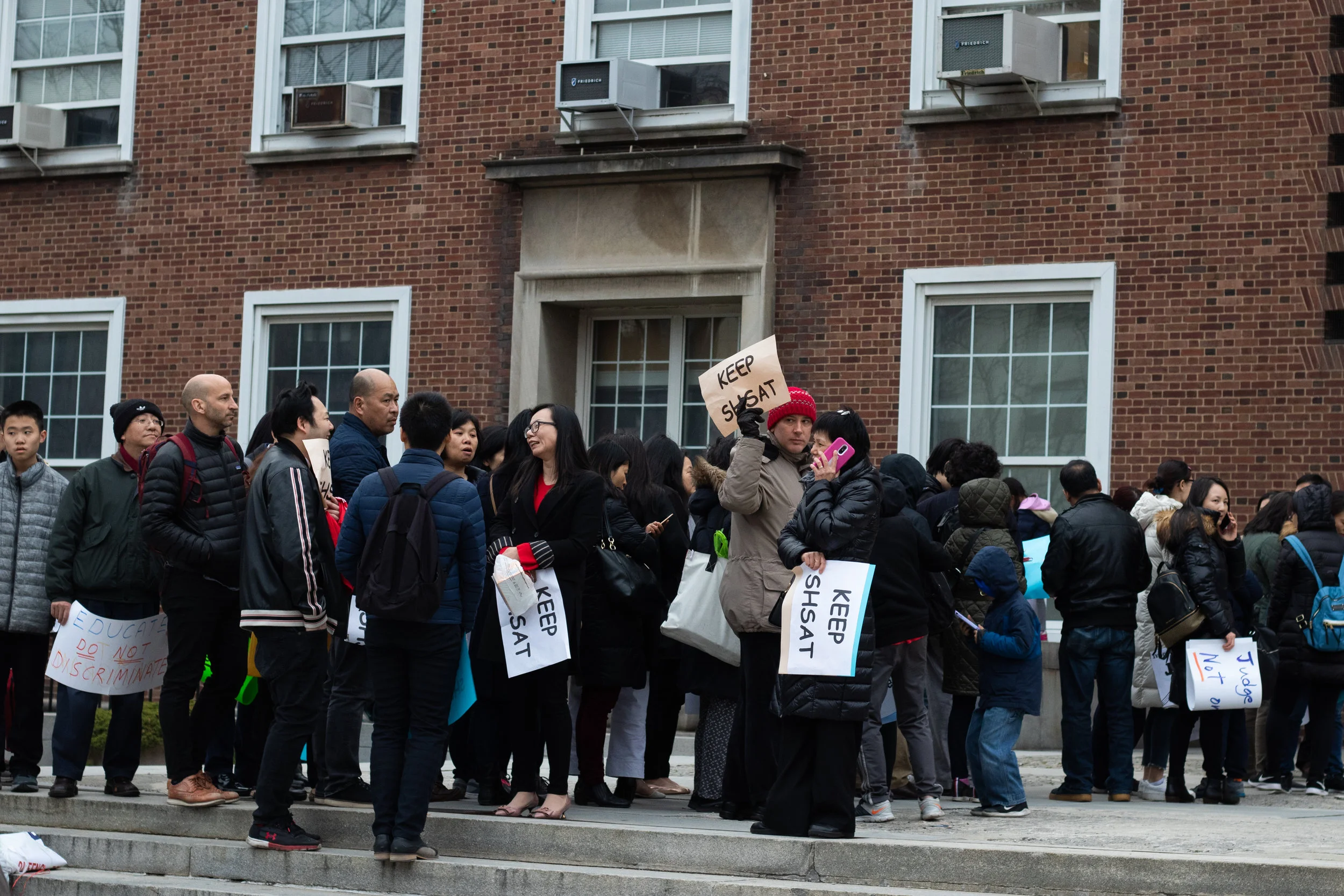 An overflow crowd attended the forum, with many demonstrators holding signs in support of the SHSAT. Eagle photo by Angel Torres.