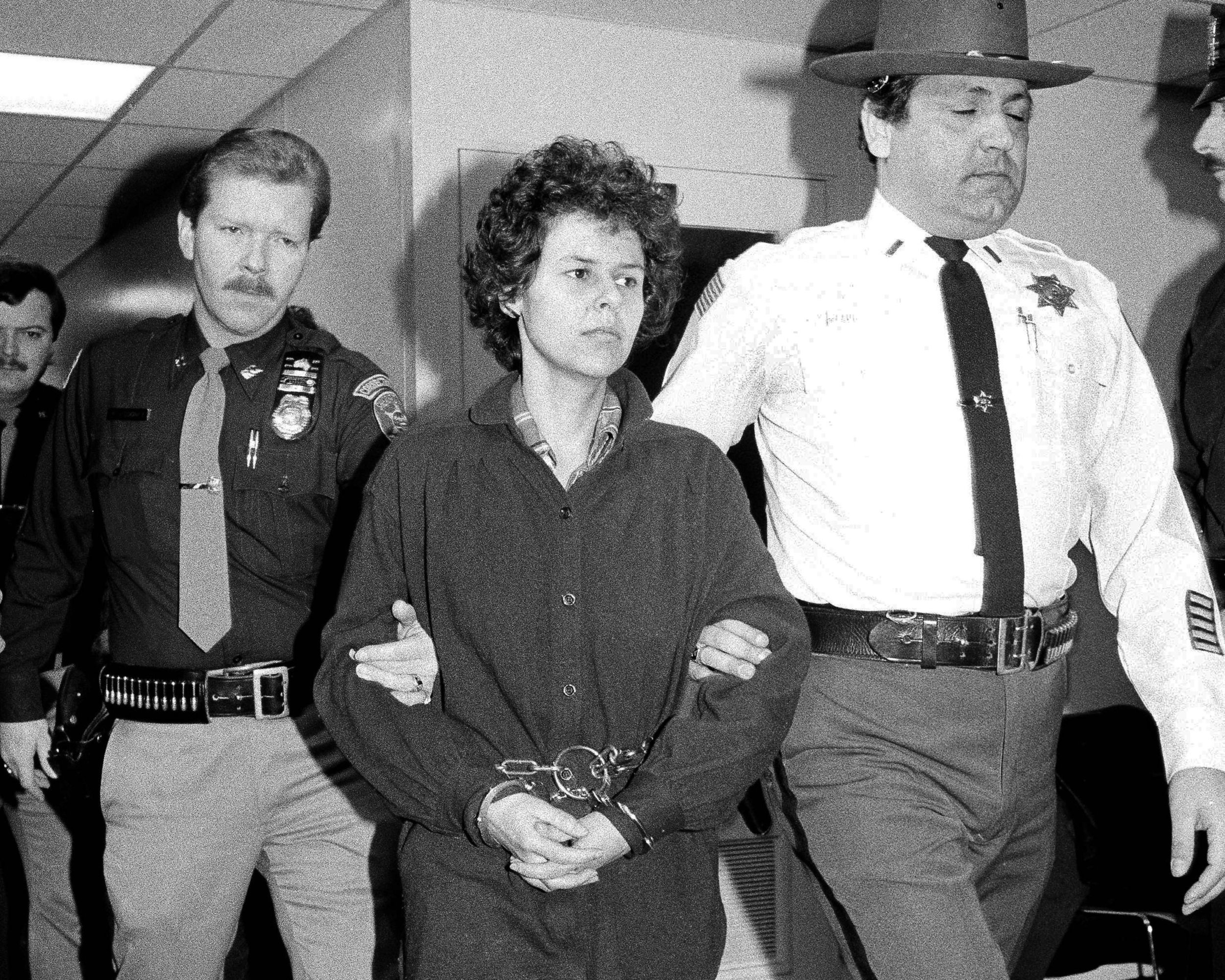 Weather Underground member Judith Clark is escorted into Rockland County Courthouse in New City, N.Y. Nov. 24, 1981 in a file photo. Clark was granted parole Wednesday, April 17, 2019, after serving more than 37 years behind bars for her role as getaway driver in a 1981 Brink's armored truck robbery that left two police officers and a security guard dead. AP Photo/David Handschuh, File.