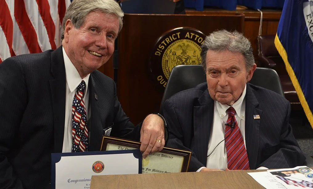 Queens Chief ADA John Ryan (left, with DA Richard Brown in 2016) announced the indictment of a Far Rockaway woman on animal abuse charges Thursday. Photo via Queens DA’s Office.