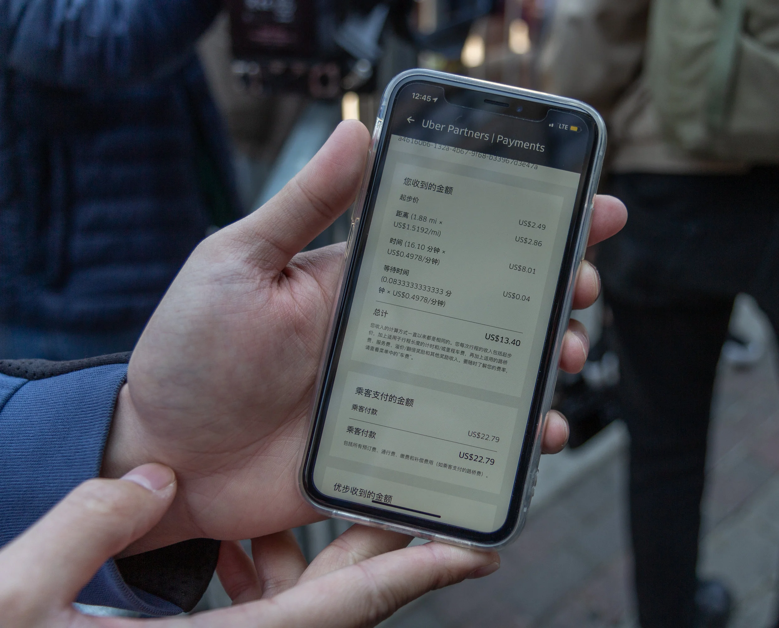 Leo Liang shows the Eagle his recent Uber payment history. On a recent 2-mile-long trip through midtown Manhattan, Liang pocketed $13.40, while the passenger paid Uber $22.79, a difference of more than 41 percent.