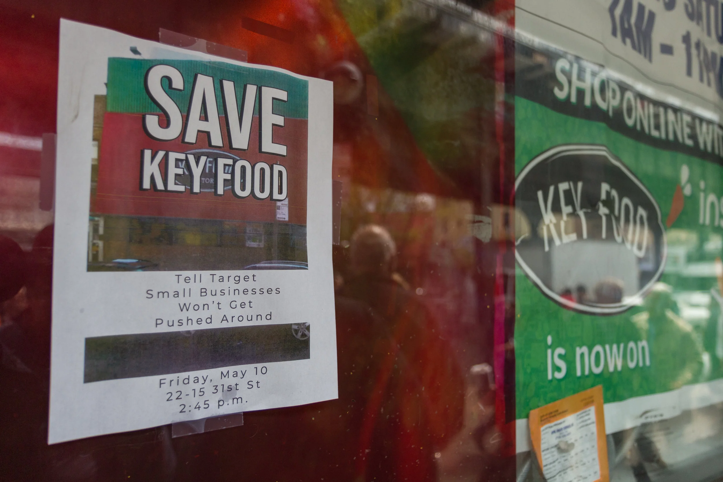 A poster advertises the rally to save the Astoria Key Food.