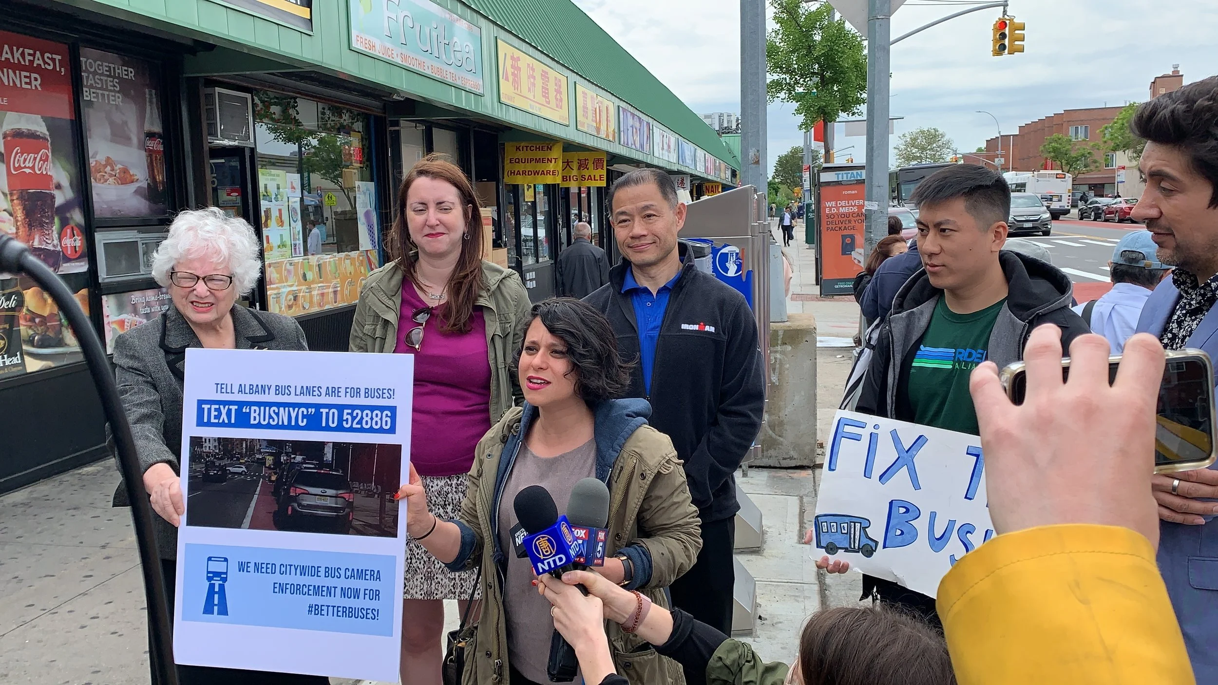 State Sen. Toby Ann Stavisky (left) and State Sen. John Liu (center) join transit advocates at a rally for Queens bus lane enforcement. Photo courtesy of Jorge Muniz/Riders Alliance.