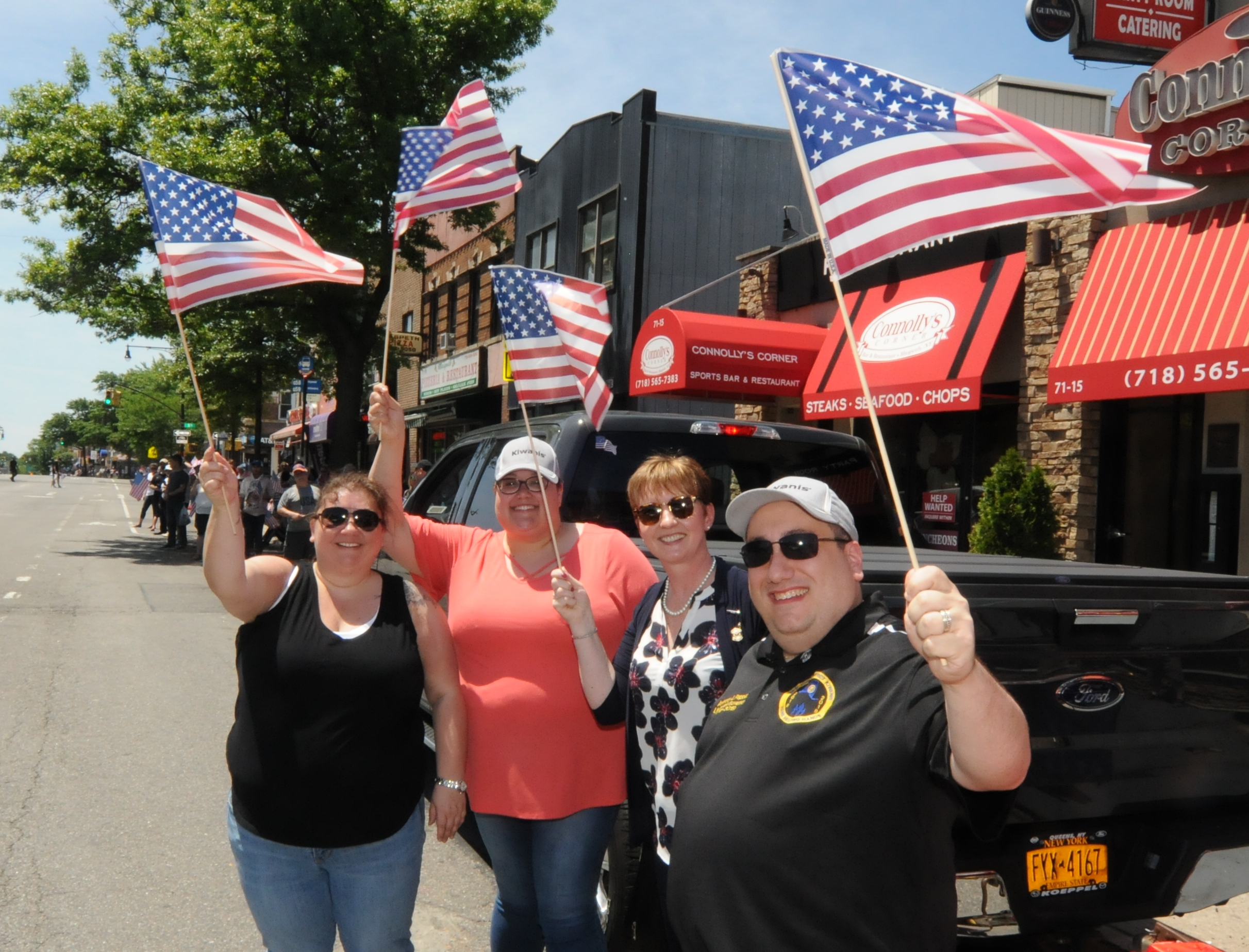  Paradegoers wave their American flags.   