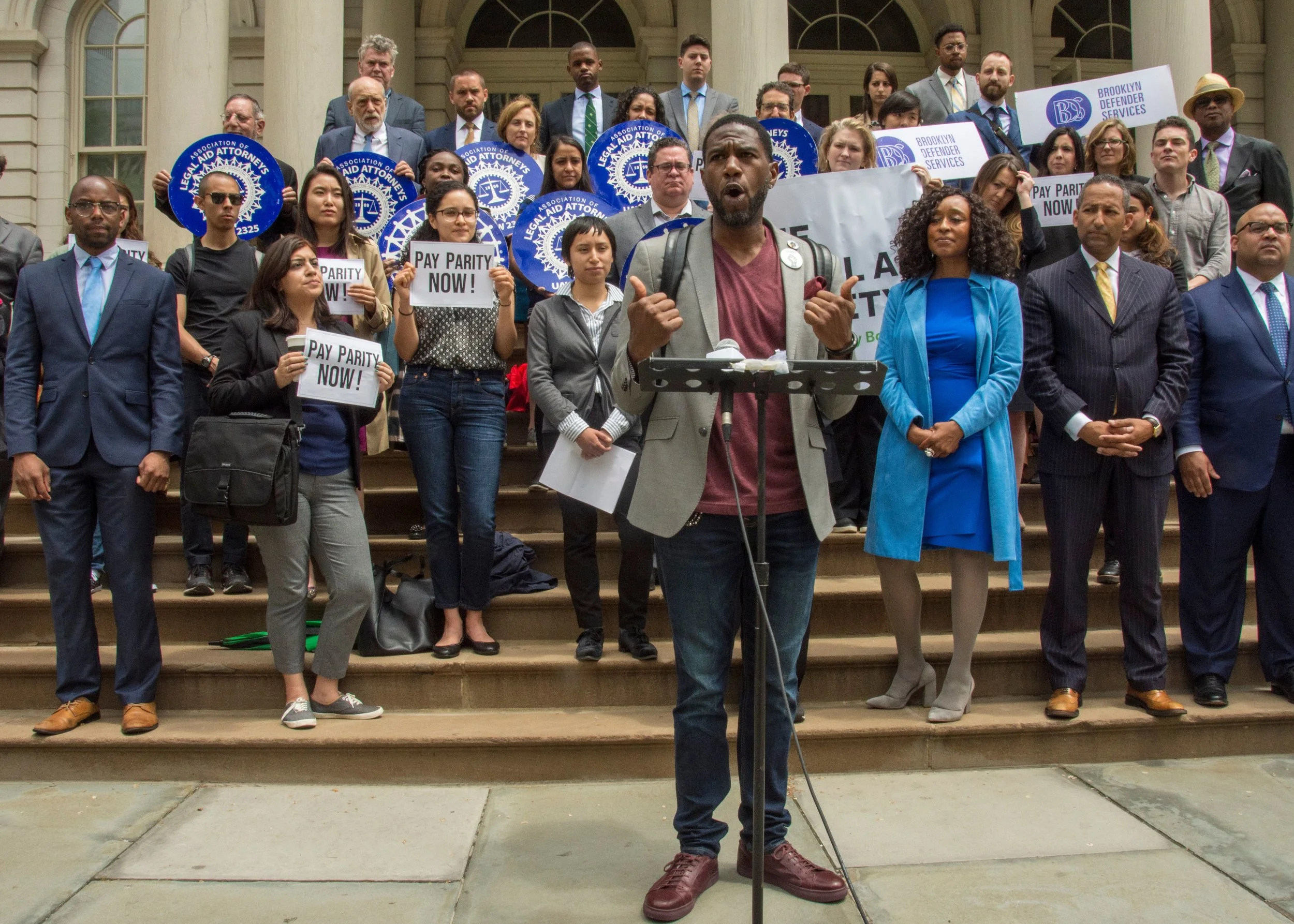 Public advocate, public defenders rally for pay parity with corporation counsel