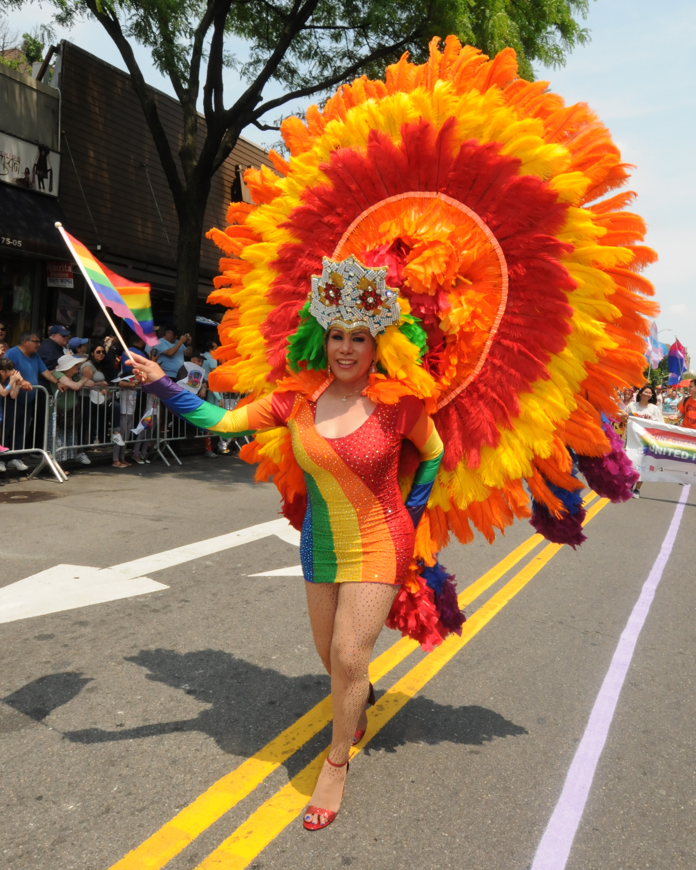  A paradegoer brightens the route in Jackson Heights.   