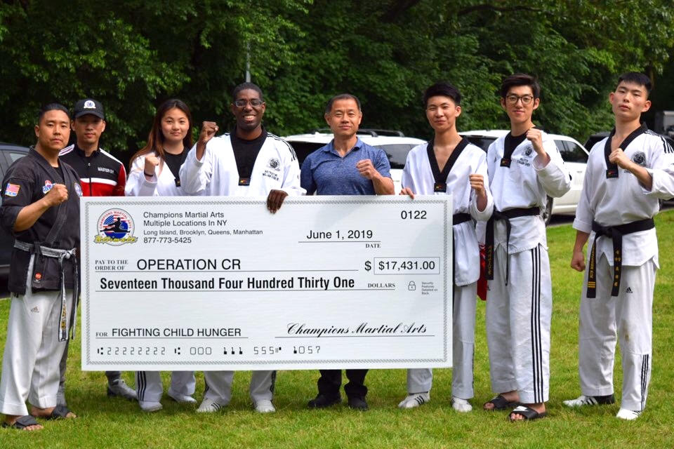 Martial arts school breaks boards for good cause