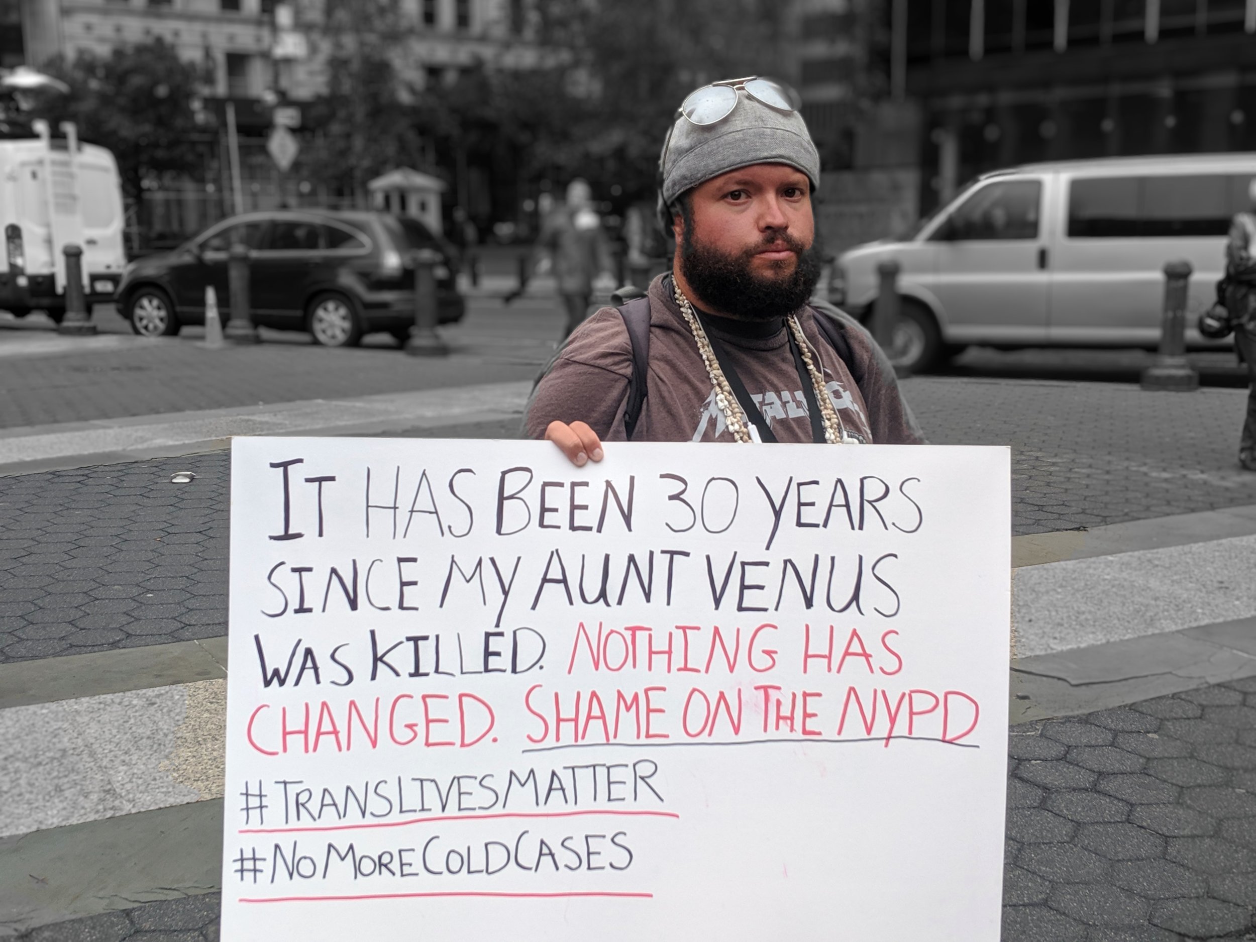 A man holds a sign at Monday’s rally for Layleen Polanco.