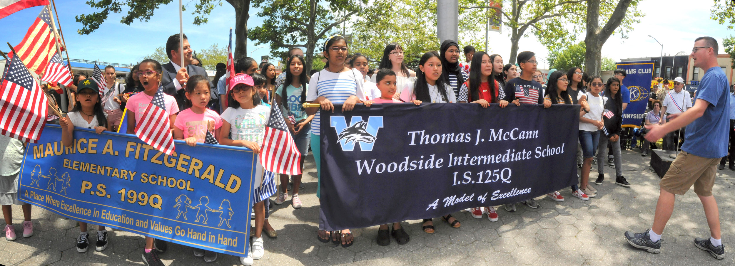 The choruses from PS 199 and IS 125 perform"God Bless America" and "This Land is Your Land.”