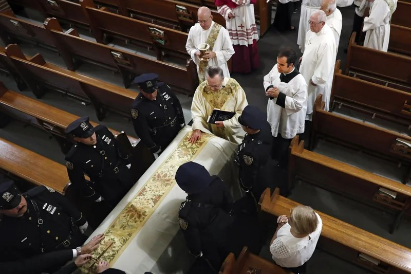 Rev. John P. Harrington blesses the casket. AP Photo/Richard Drew, Pool. AP Photo/Richard Drew, pool.