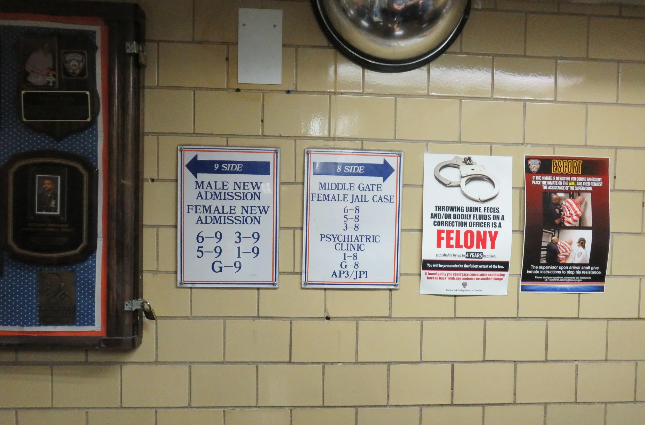 Signs warn detainees not to assault correction staff.