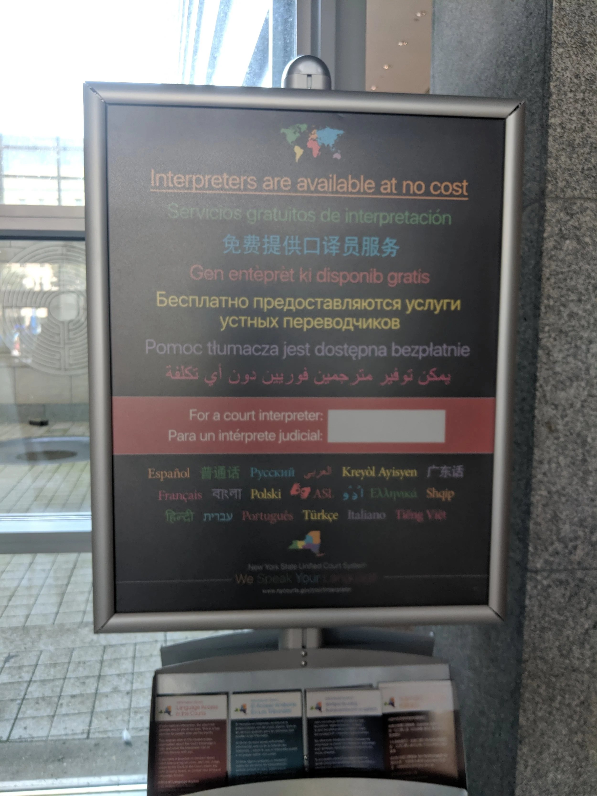 A sign in Housing Court advertises interpreter services. Eagle photo by Phineas Rueckert