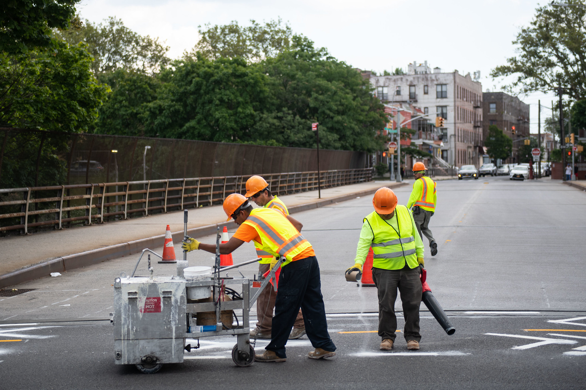 City workers paint new bike lane lines on a street. Michael Appleton/Mayoral Photography Office.