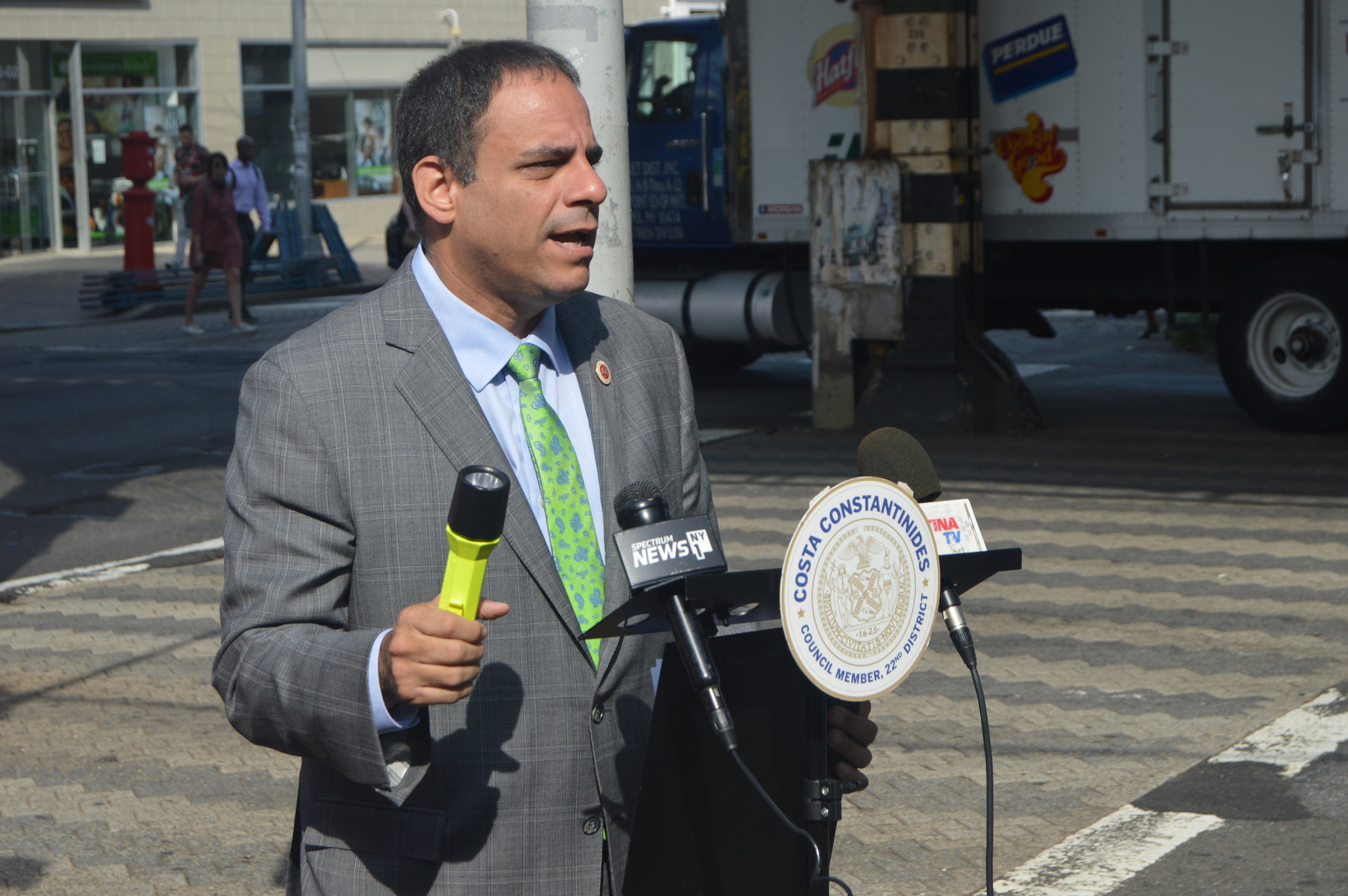Constantinides holds the flashlight at a rally in support of installing netting under the entire Astoria line. Monday. Photos courtesy of Constantinides’ office.