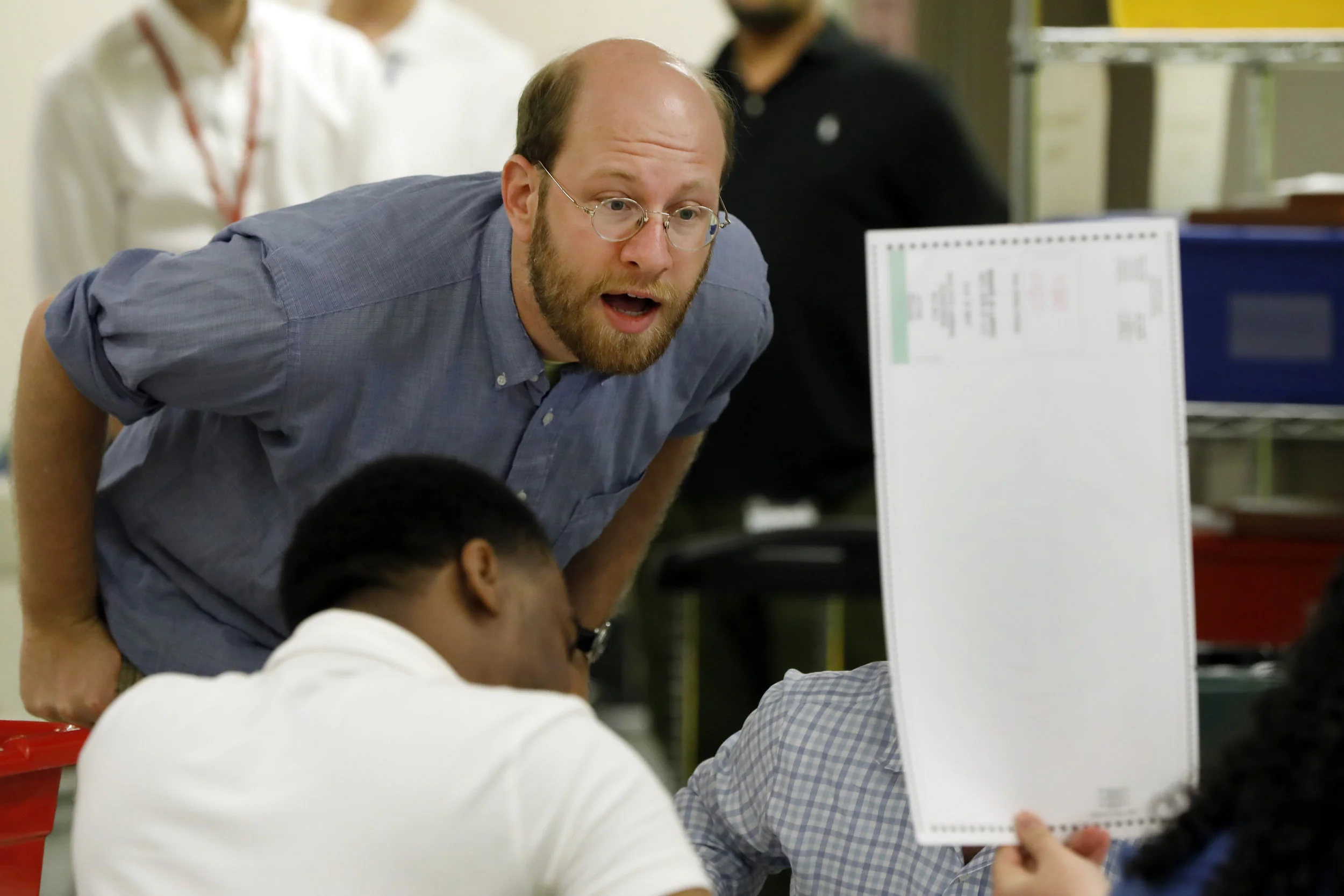 A Board of Elections official inspects a ballot during the manual recount in the Democratic primary for Queens DA last month. AP Photo/Seth Wenig.