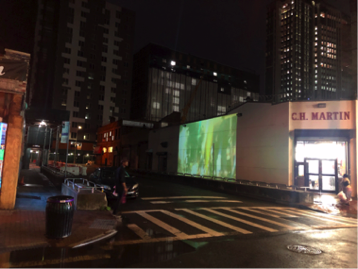 “The Ave” projected on the side of CH Martin and Rincon Salvadoreno, off Jamaica Ave. Photo by Jason Lalor.