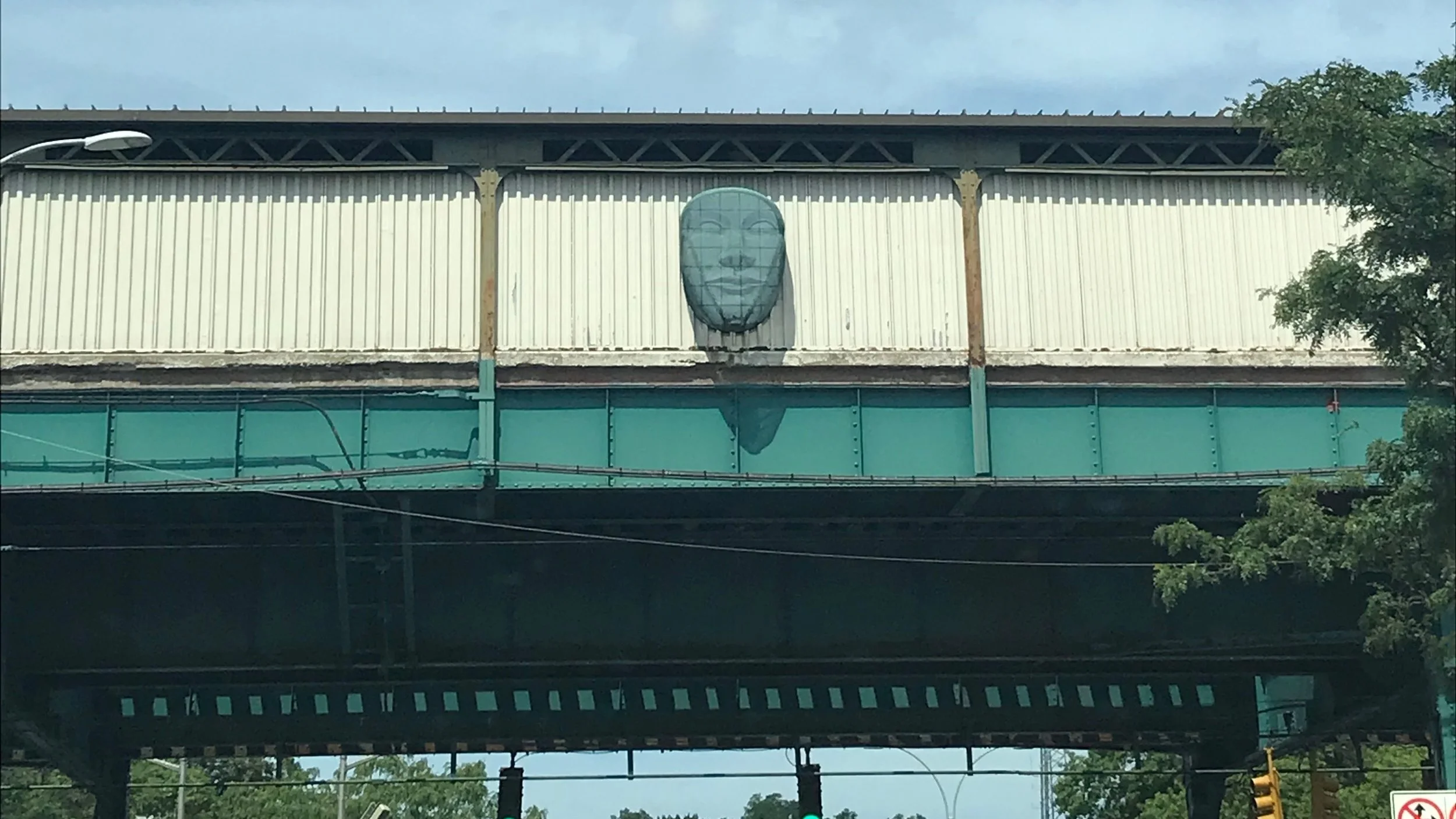One of five sculpted faces watch over the Woodhaven Boulevard subway station in Woodhaven. Eagle photo by Jonathan Sperling.