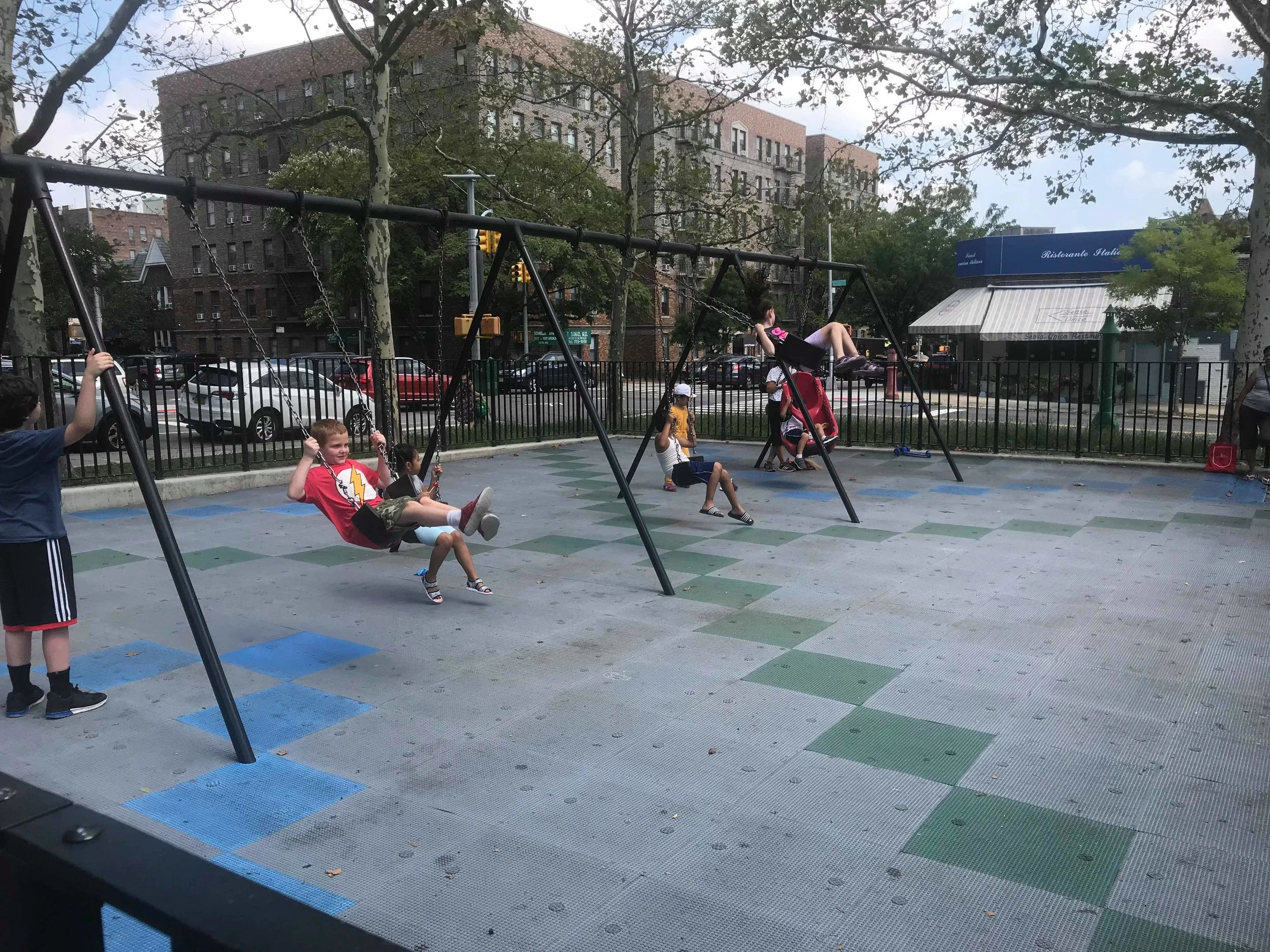 Children swing at the Thomas P. Noonan Jr. Playground near P.S. 150 in Sunnyside on Wednesday, the day before the new school year began. Eagle photo by Amanda Glodowski.