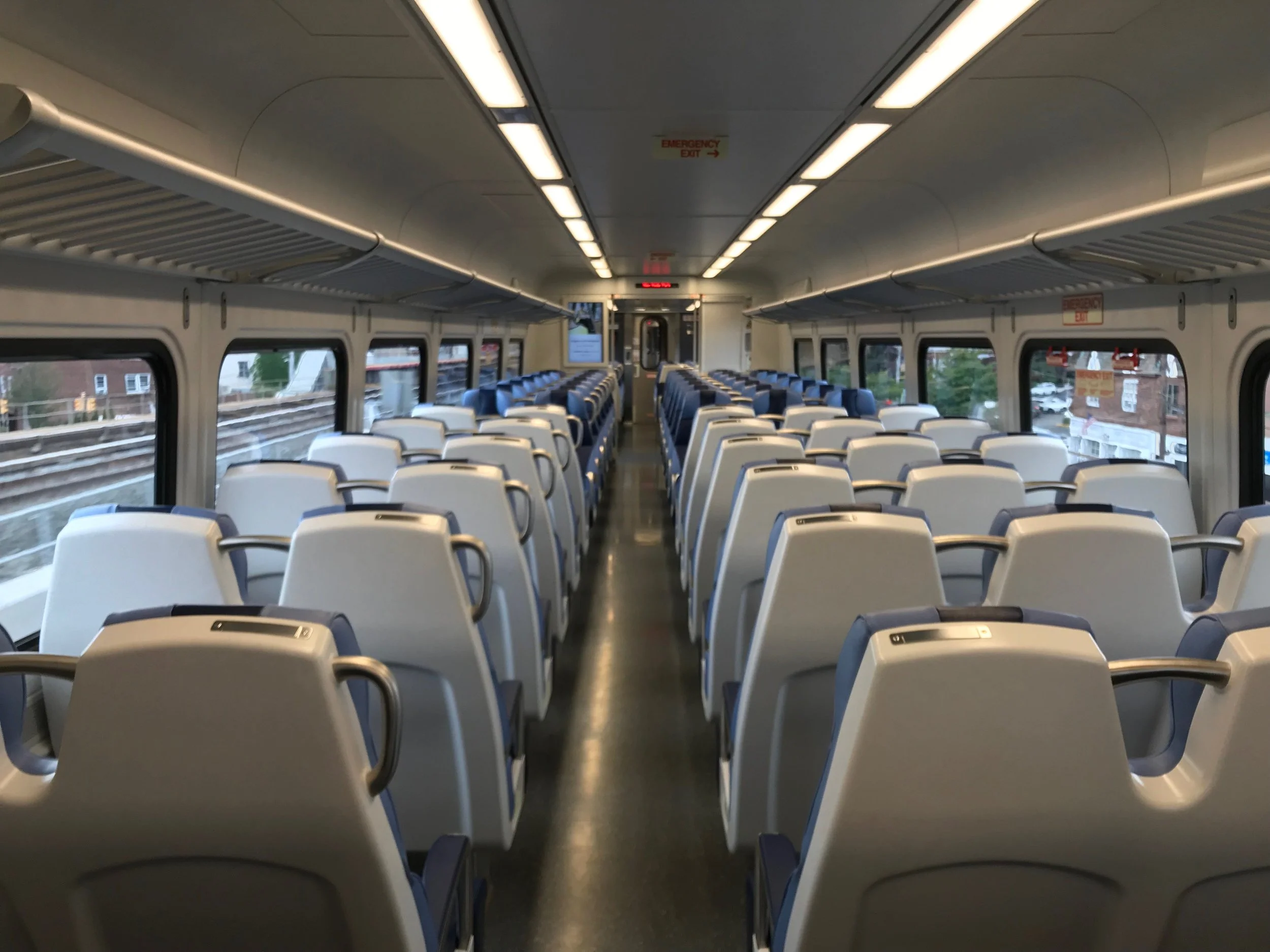 The new M9 cars feature wider seats, additional seating and electrical outlets on both sides of the car in every seat row. Photo via the LIRR.