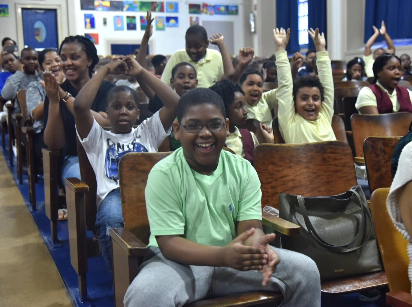 New York City’s Participatory Budgeting Steering Committee has urged the Council to revive the initiative, which they say drives civic engagement. In this photo, Brooklyn children learn their school has been selected for renovations in a 2018 participatory budgeting vote. Photo by Jeff Reed/City Council Photography