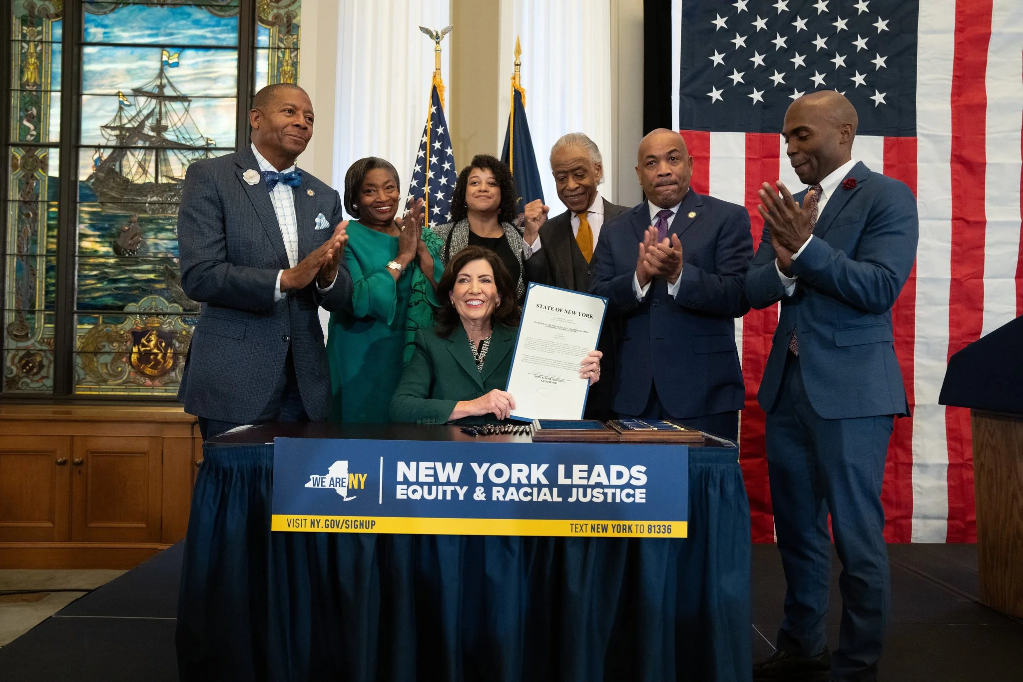 Gov signs Queens pol’s reparations bill into law
