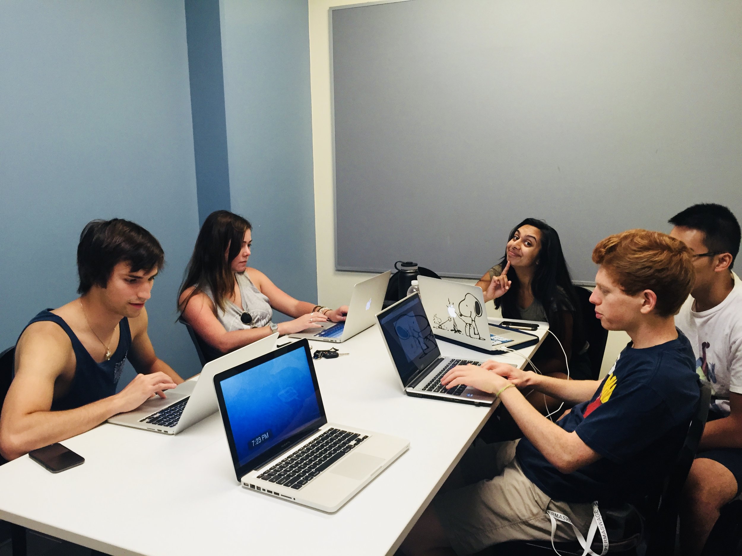 Students connect on campus during a project meeting. 